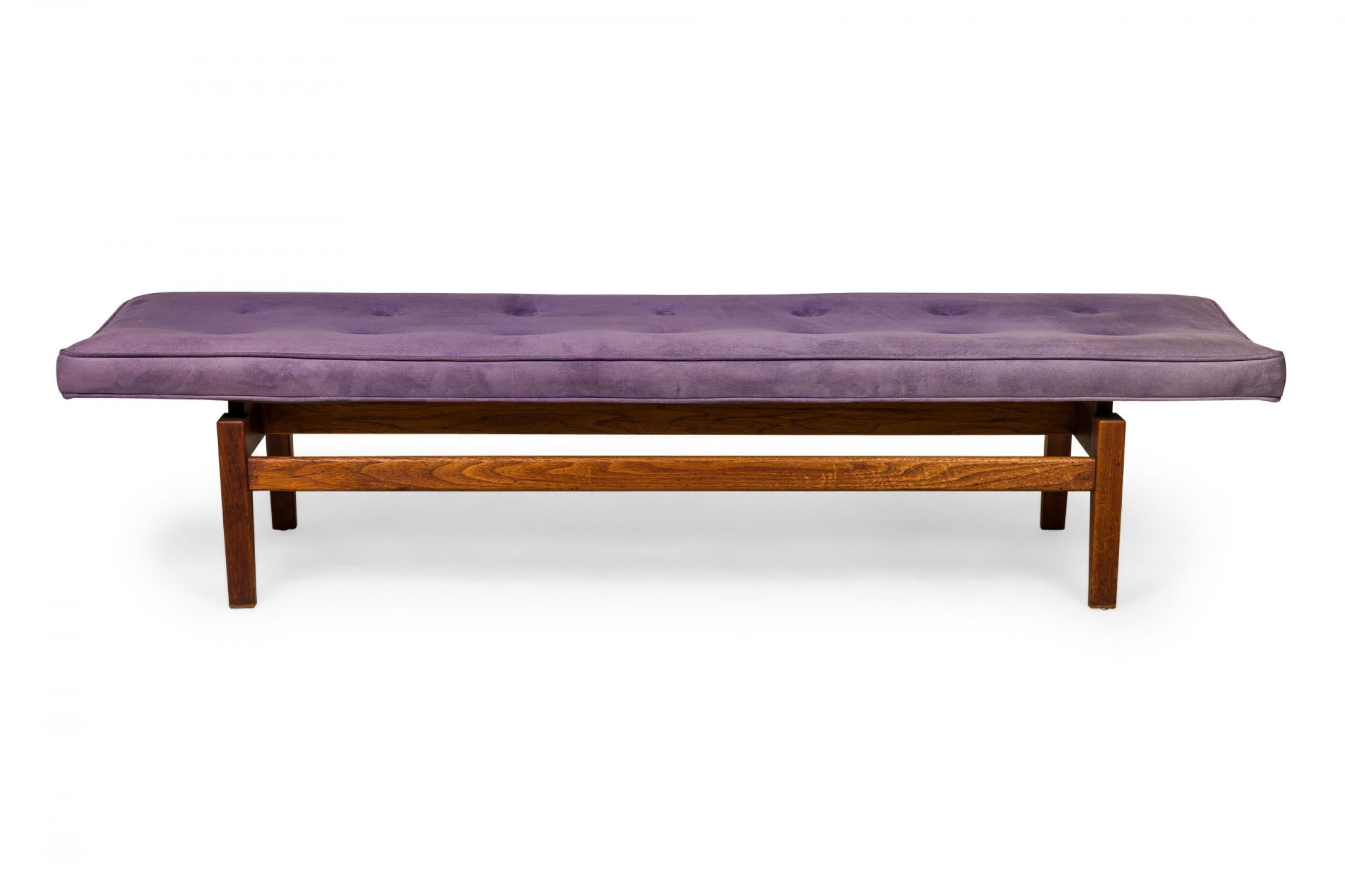 Danish Mid-Century rectangular floating bench with a purple button tufted velour seat resting on a wooden floating frame base. (JENS RISOM).
 