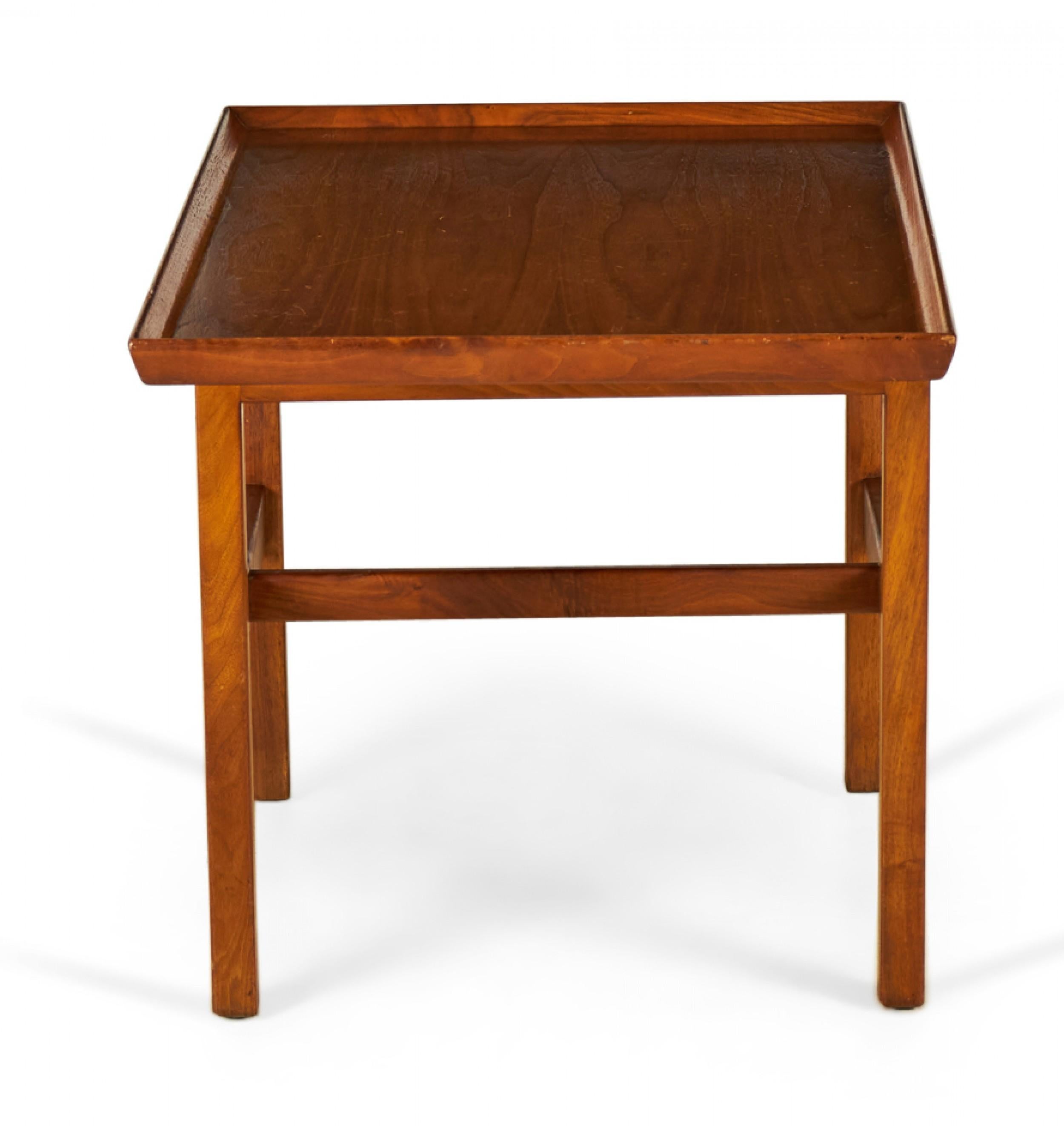 Danish mid-century walnut cantilever side / end table with a rectangular off-center tabletop with shallow gallery supported by a walnut stretcher base. (Jens Risom).
    