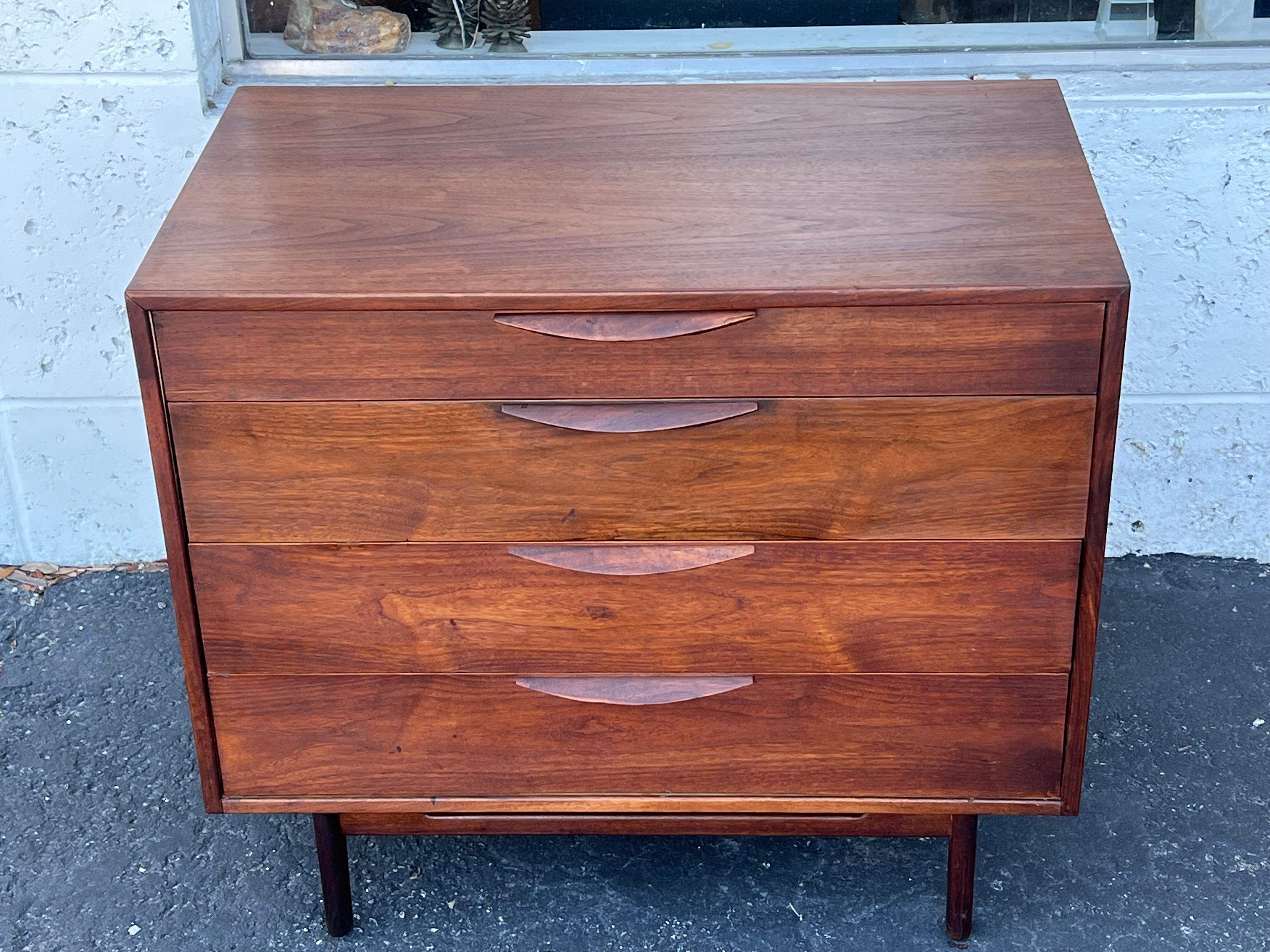 A classic dresser by Jens Risom with nice patina, walnut, ca' 1960's. Four drawers with nicely sculpted handles. Unusual base with cutouts. 