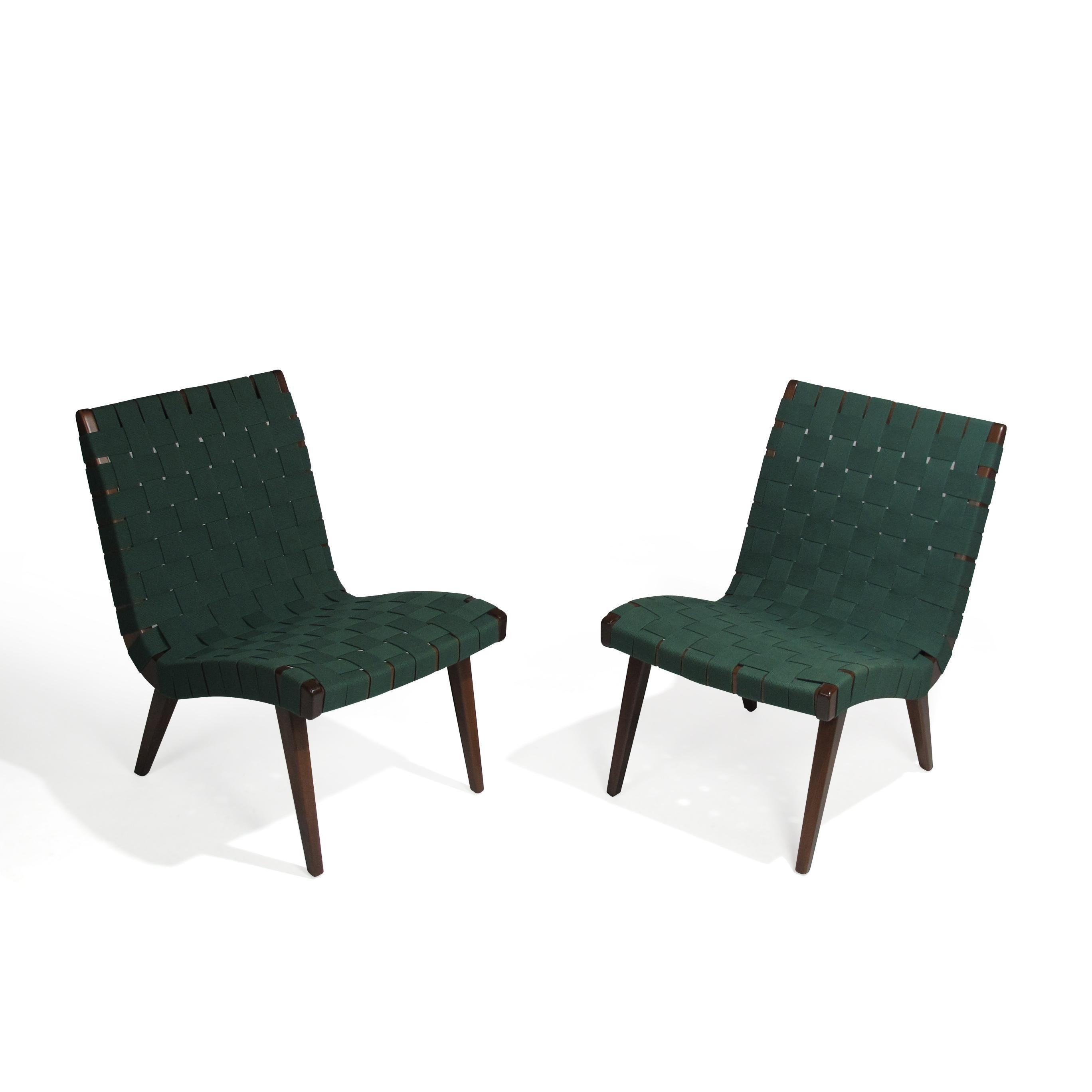 Pair of armless lounge chairs designed by Jens Risom for Knoll. Frames of solid maple with an ebonized walnut finish and forest green cotton webbing.
