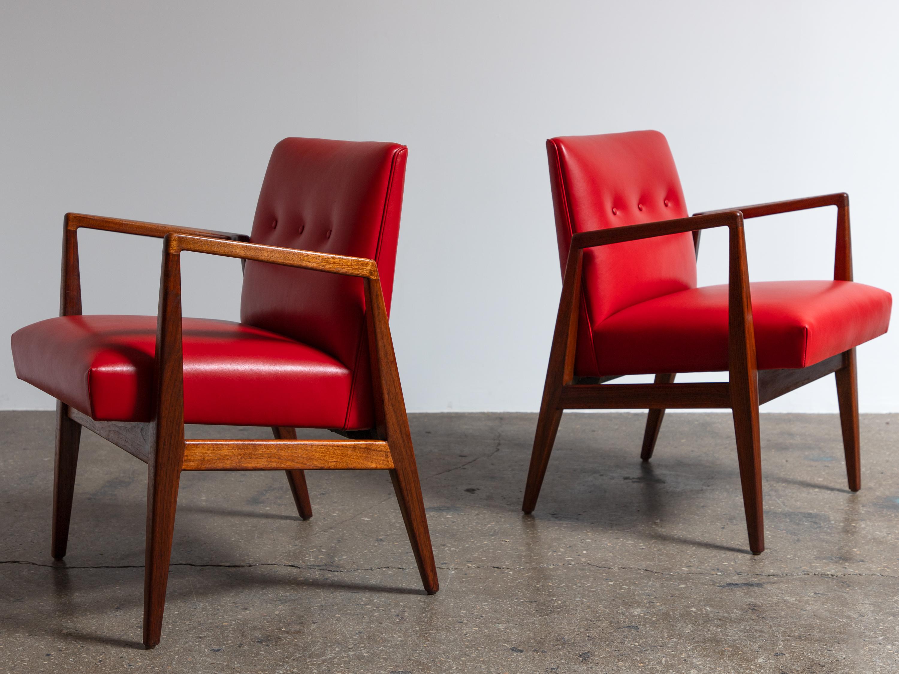 Pair of poised and elegant model 1103 armchairs, designed by Jens Risom for his eponymous company Jens Risom Design Inc.  Showcasing the designer’s fusion of Scandinavian and American design, the chair features angular walnut wood frames with