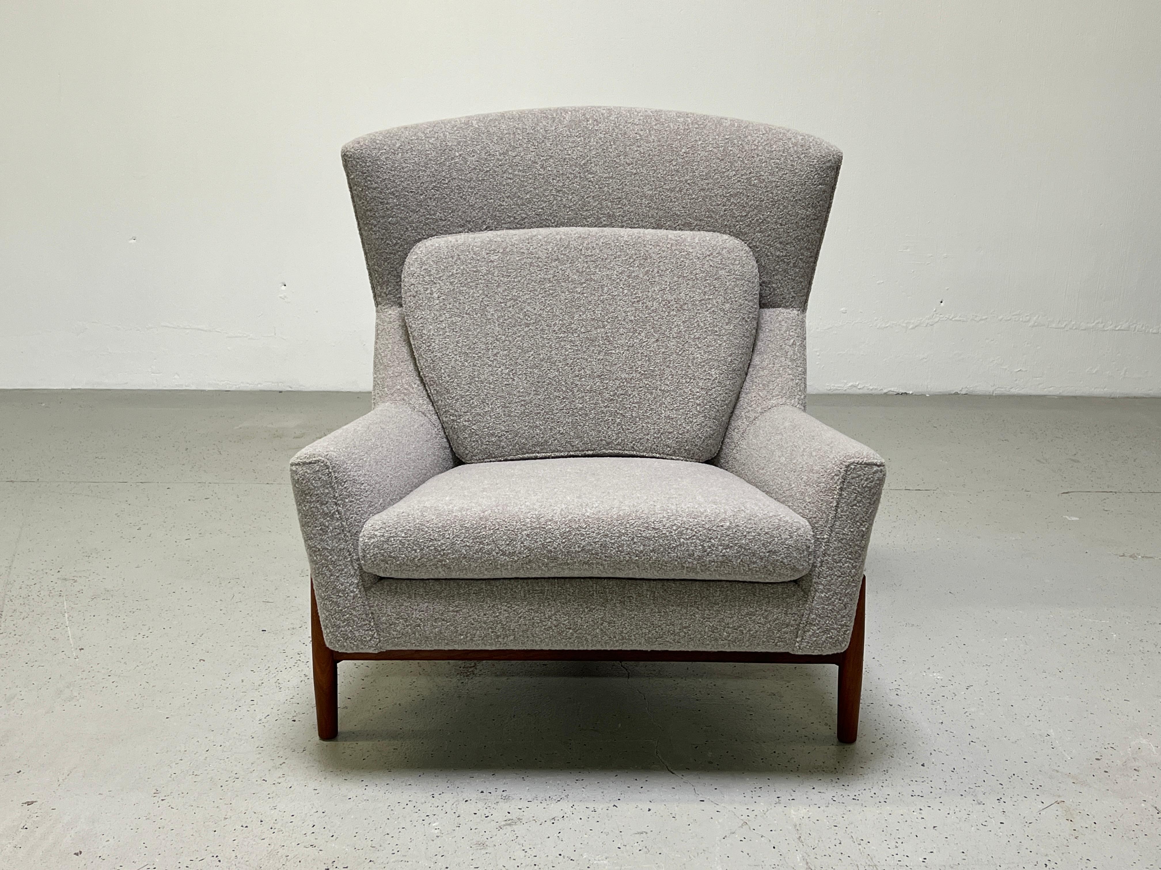 A rare lounge chair designed by Jens Risom for Risom Designs, Inc. Beautifully restored with refinished walnut base and upholstered in 
Holly Hunt / Vladimir: Silver Fog.