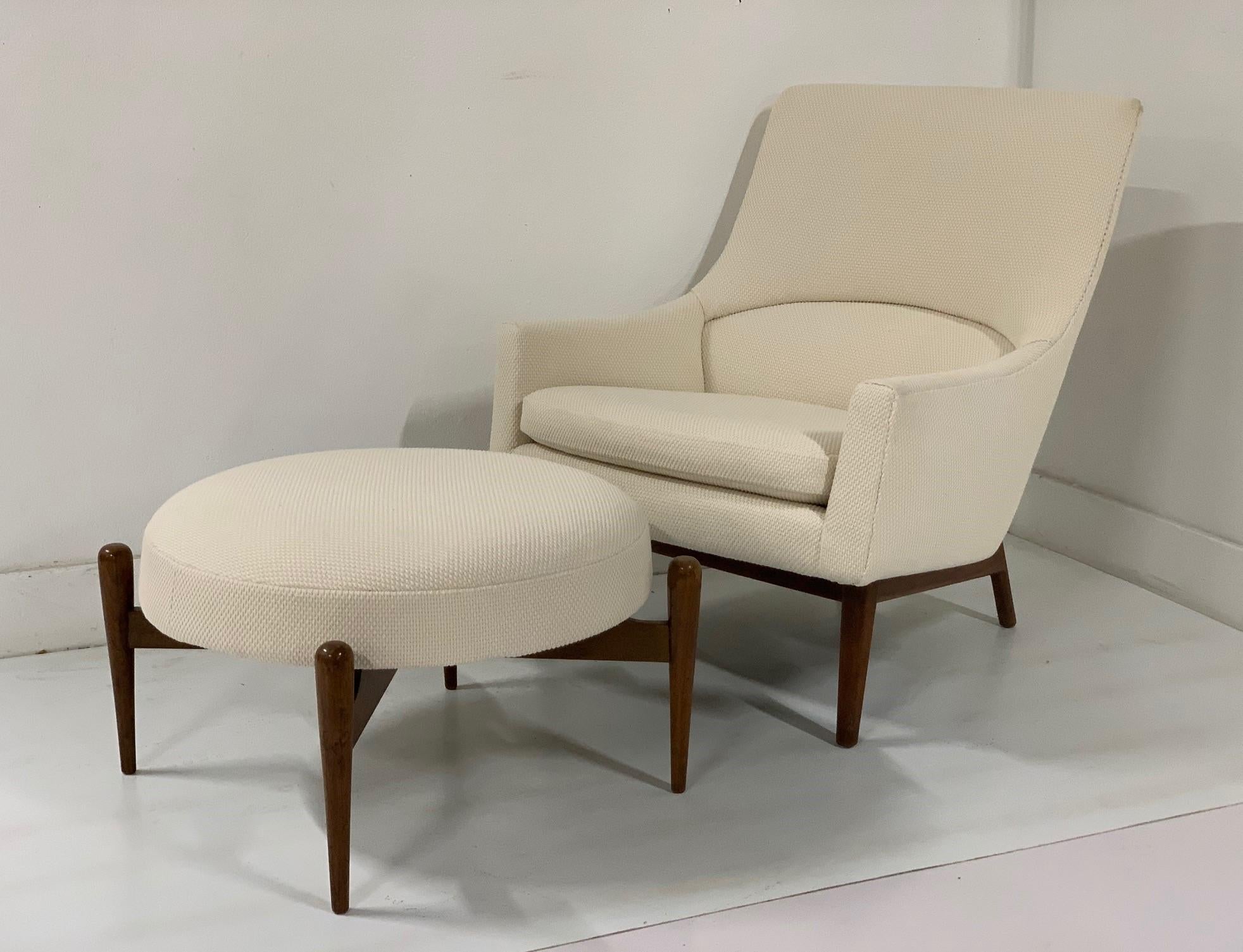 Jens Risom lounge A-Chair with a rare matching ottoman. Sculptural solid walnut frame and newly upholstered. Mid Century Modern.

Originally designed by Jens Risom in 1961 the A-Chair is a graceful expression of an elegant, upholstered chair in a