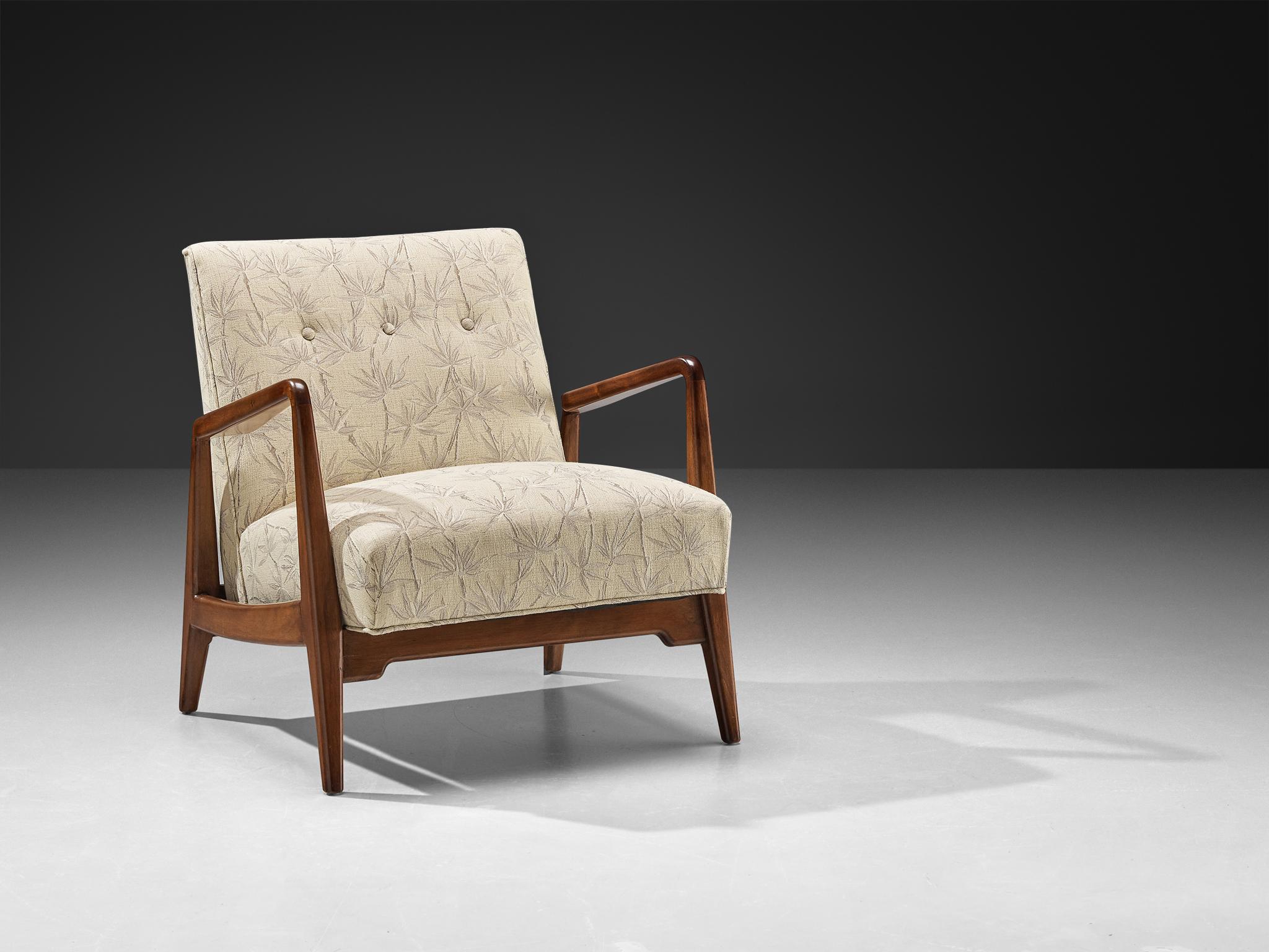 Jens Risom, sedia da salotto, noce e tessuto, Stati Uniti, anni '60.

Questa poltrona è stata disegnata da Jens Risom. Il telaio in noce funge sia da base strutturale che da elemento visivo di definizione, le sue linee nitide e angolari riflettono