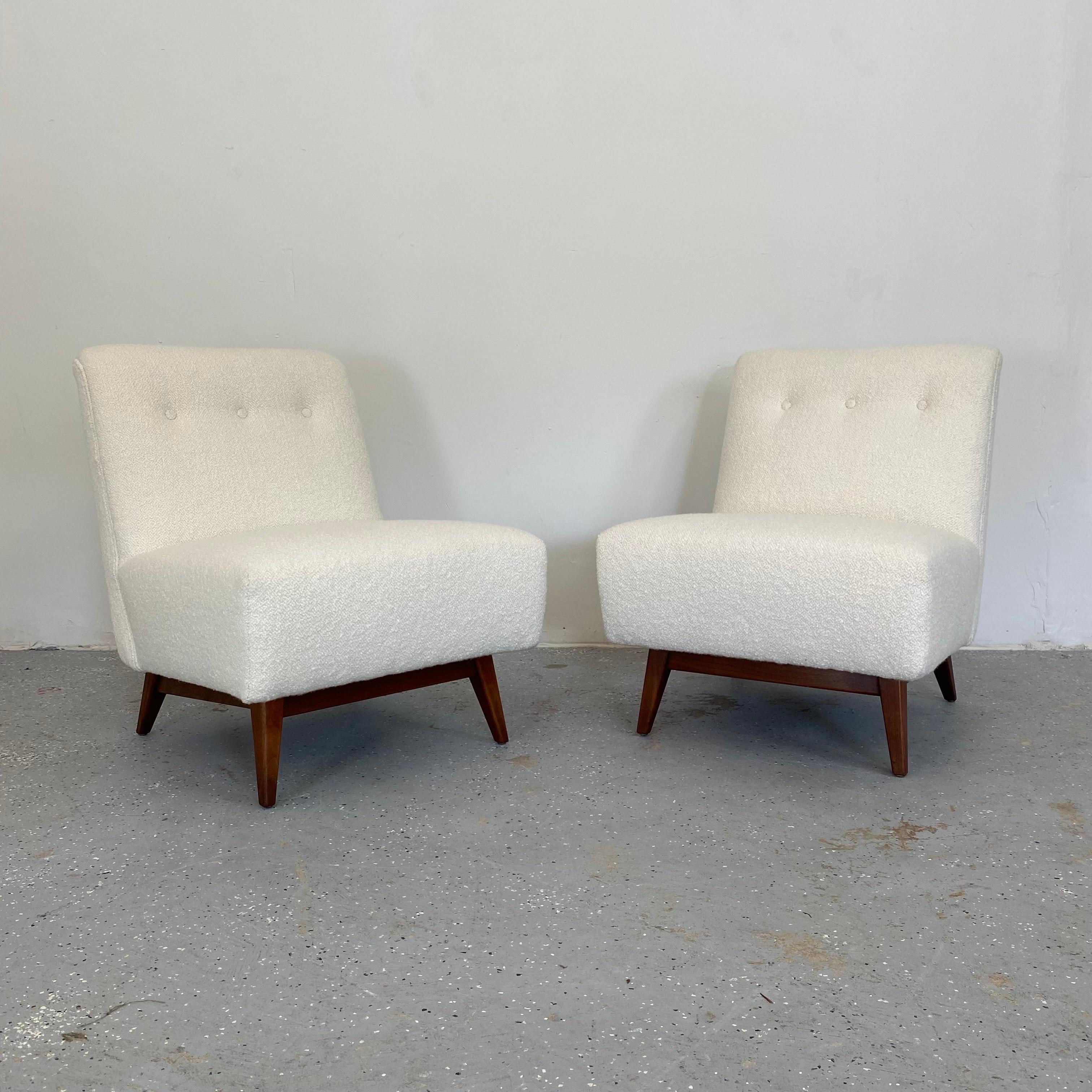 Sleek lounge chairs from Jens Risom newly upholstered in a luxurious boucle atop walnut frames. A classic mid century modern look to this pair.