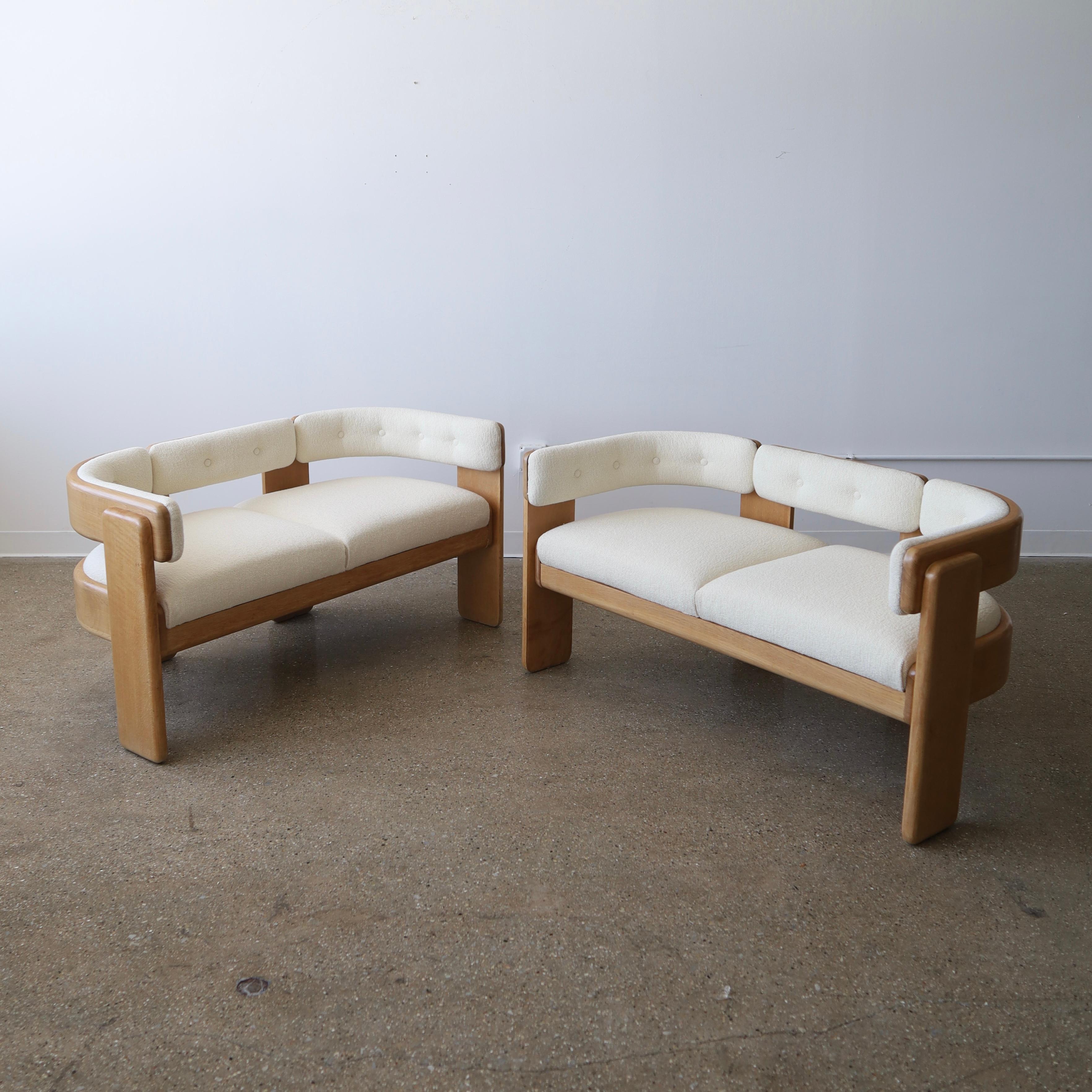 c. 1970s, signed. Both have been fully refinished and reupholstered in Maharam Hearth with new foam. There is still age-appropriate wear though including light cracking, chips to the feet, minor dents, scratches, and some discoloration on some of