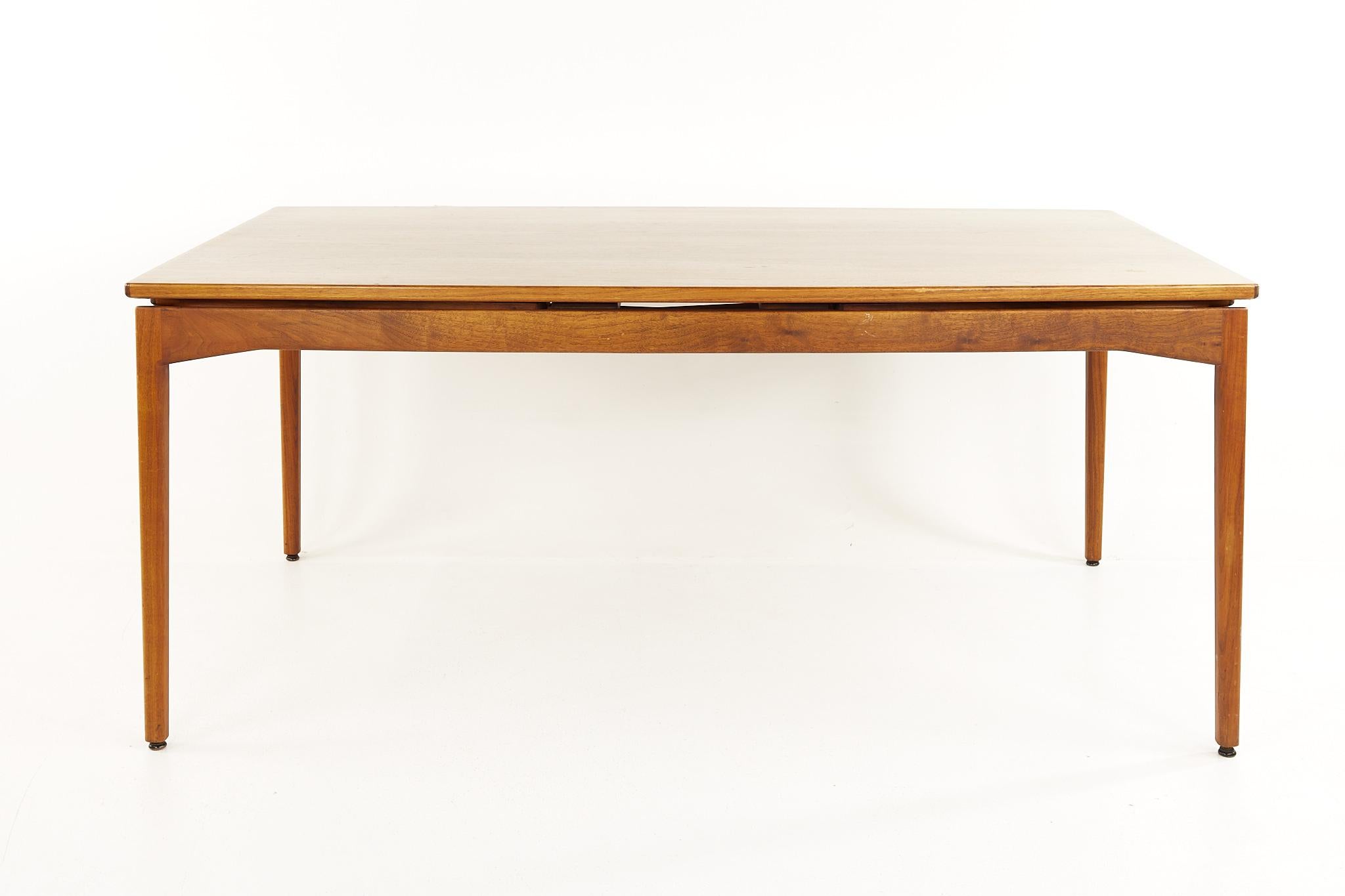 Jens Risom mid century walnut dining table hidden leaf dining table with 2 leaves

The table measures: 68 wide x 42 deep x 29.25 high, with a chair clearance of 25 inches; each leaf is 25 inches wide, making a maximum table width of 118 inches