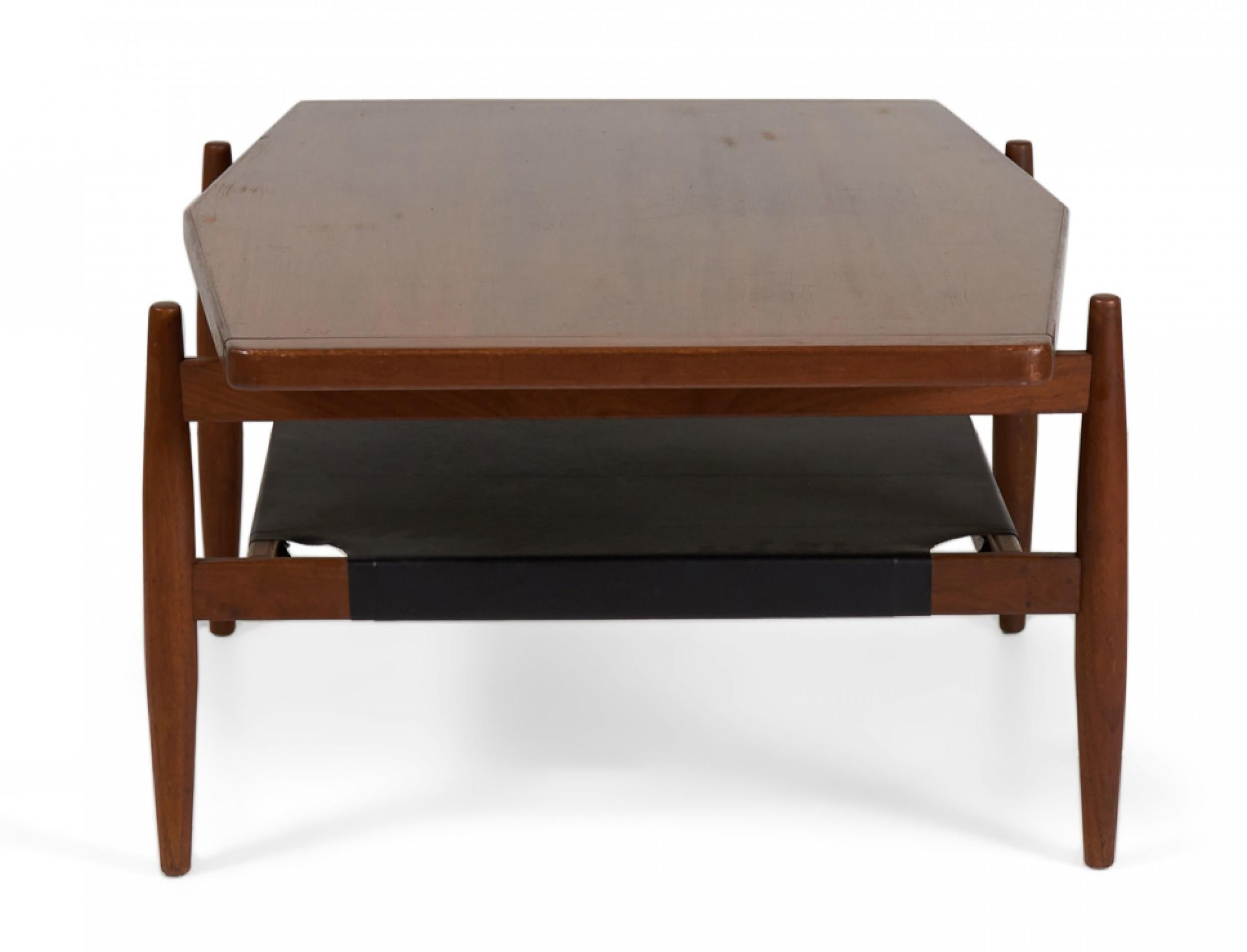 American/Danish Mid-Century walnut coffee table with a gently diamond-shaped top resting on a structured stretcher base with four tapered legs and stretcher shelf made of stretched black vinyl. (JENS RISOM)(Similar tables: DUF0091A, DUF0091B)
