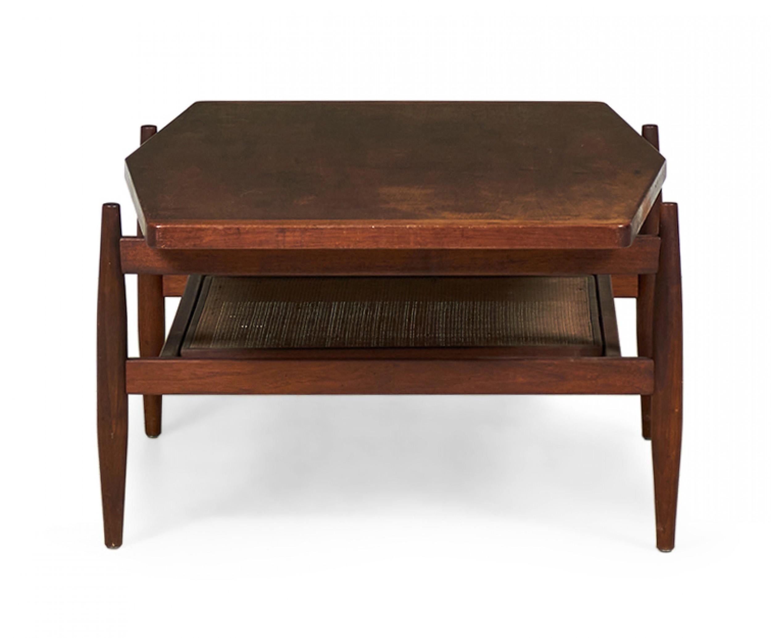 American/Danish Mid-Century walnut coffee table with a gently diamond-shaped top resting on a structured stretcher base with four tapered legs and stretcher shelf with caned inset. (JENS RISOM)(Similar tables: DUF0091B, DUF0091C)
