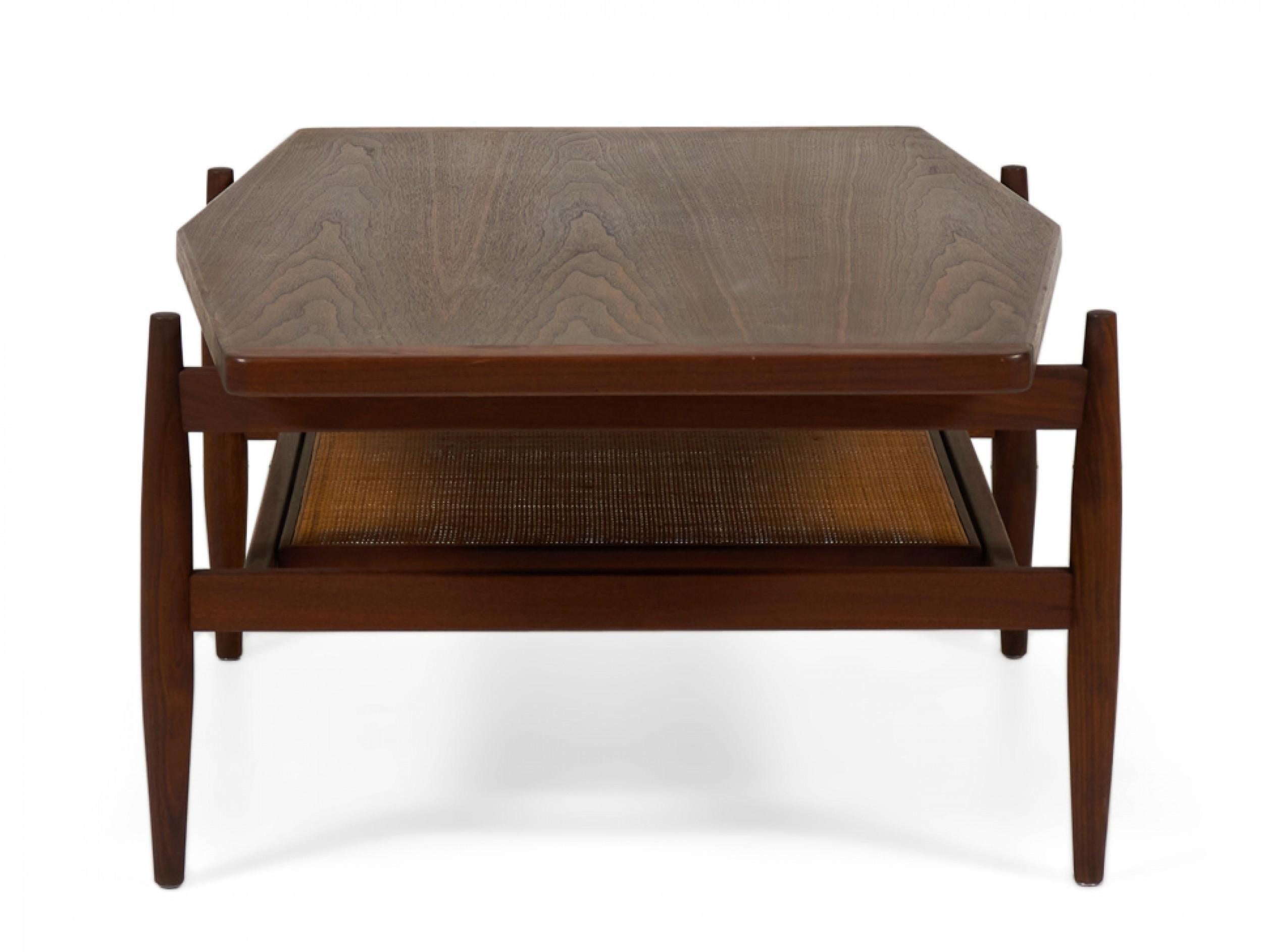 American/Danish Mid-Century walnut coffee table with a gently diamond-shaped top resting on a structured stretcher base with four tapered legs and stretcher shelf with caned inset. (JENS RISOM)(Similar tables: DUF0091A, DUF0091C)
