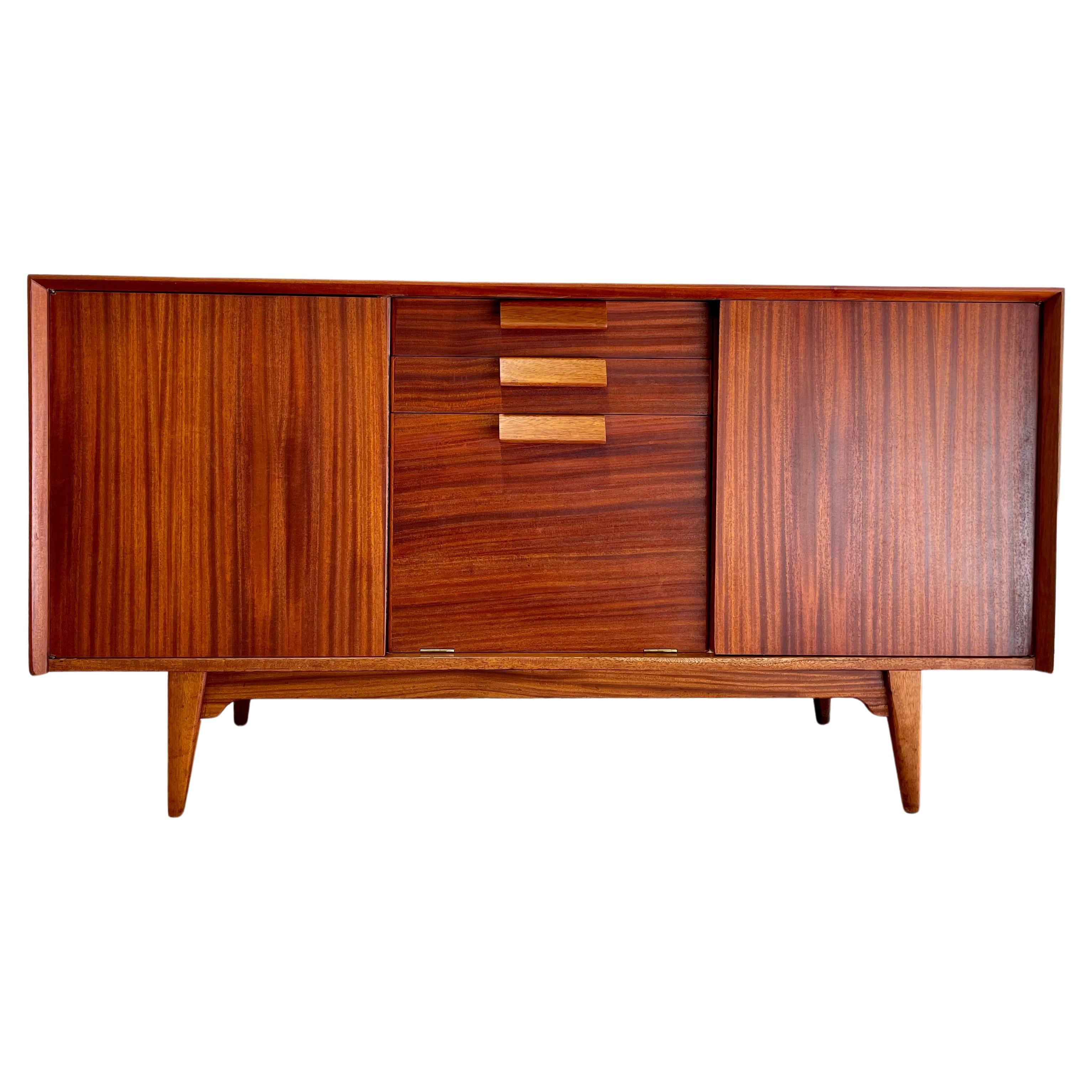 Gorgeous Jens Risom Mid Century Modern Credenza / Media Stand, c. 1960's. This rare sideboard by Jens Risom offers a wealth of storage space among two shelving areas with adjustable or removable shelving (two shelves pictured but three are included)