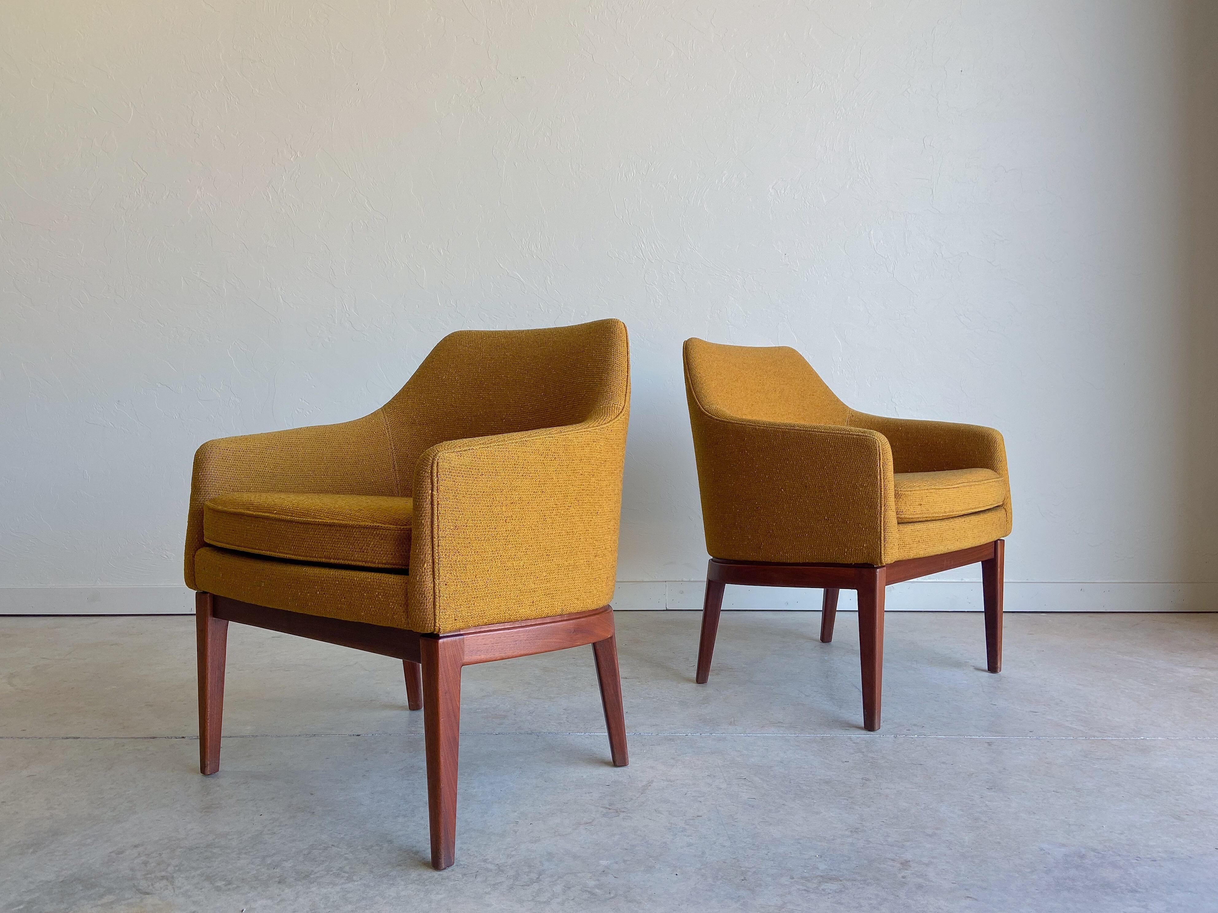 Offered is an amazing pair of armchairs designed by Jens Risom for Jens Risom Inc.

Beautiful and substantial walnut frames support the well proportioned seats which retain their original nubby yellow ochre upholstery. The upholstery is truly in
