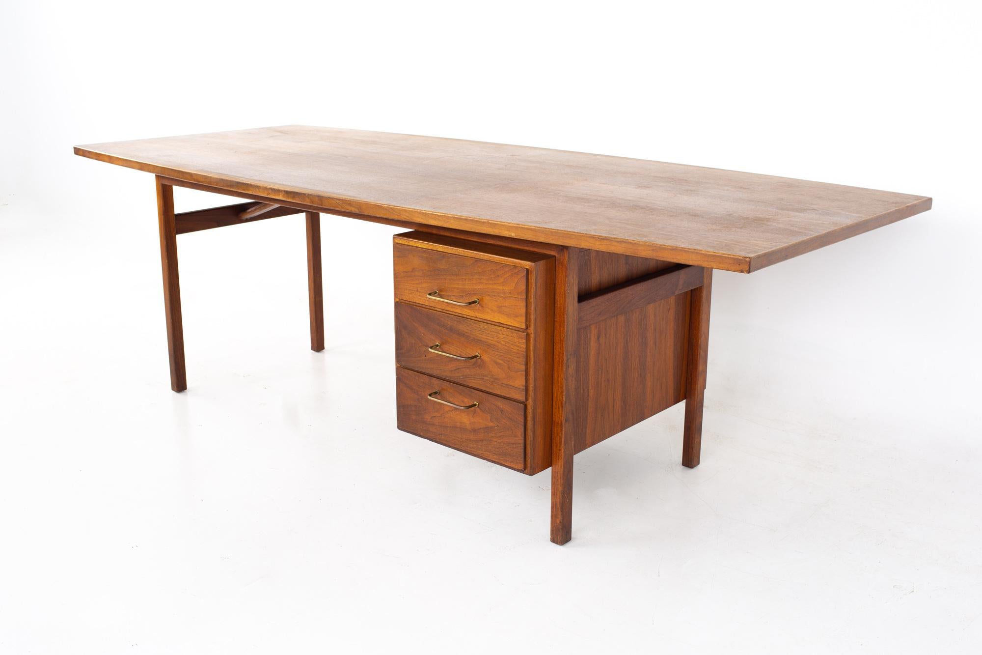 Jens Risom mid century surfboard walnut executive desk.
Desk measures: 96 wide x 42 deep x 29.5 inches high

All pieces of furniture can be had in what we call restored vintage condition. That means the piece is restored upon purchase so it’s