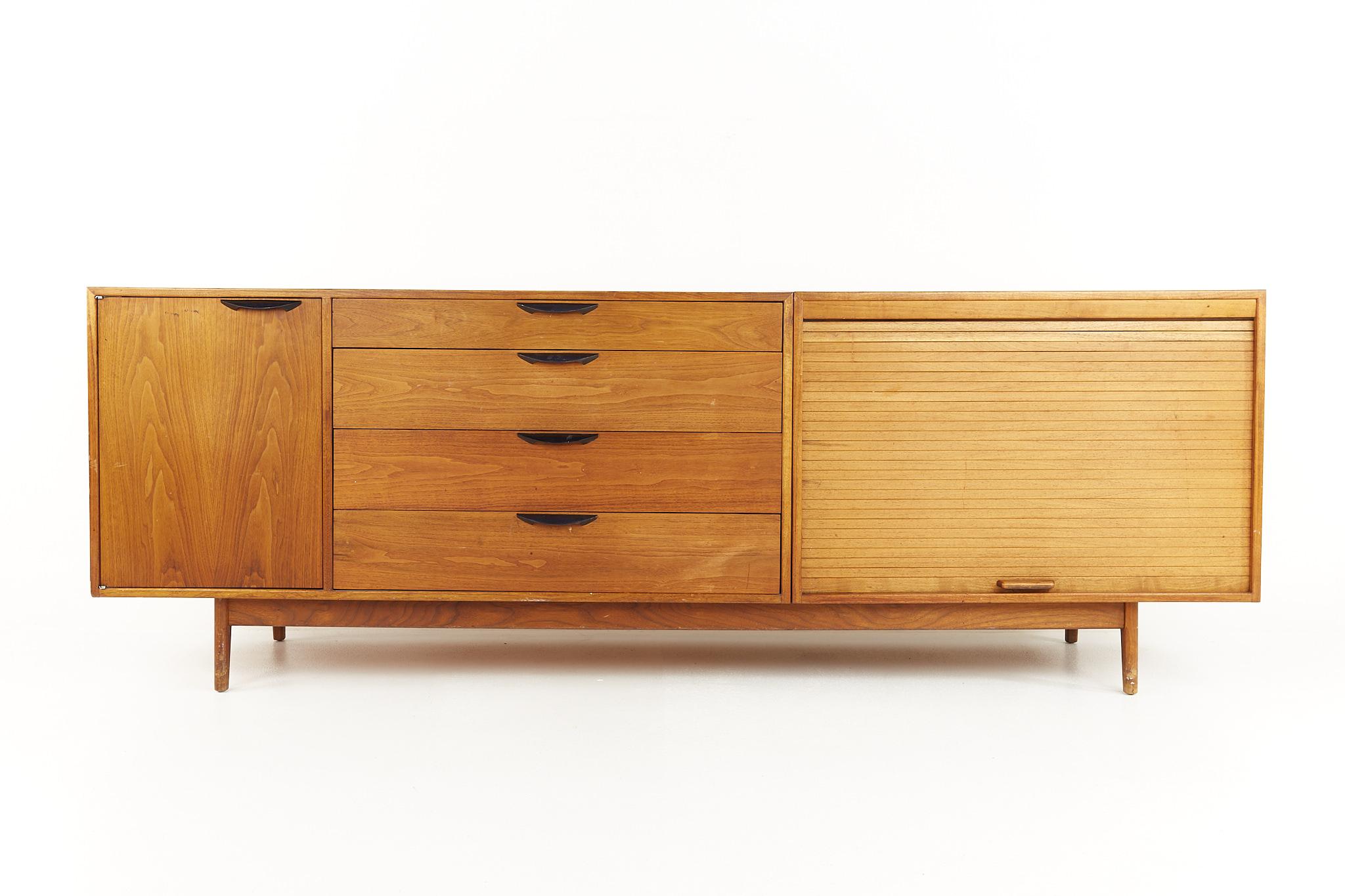 Jens Risom Mid Century tambour door credenza

Credenza measures: 90 wide x 21 deep x 31.75 inches high

All pieces of furniture can be had in what we call restored vintage condition. That means the piece is restored upon purchase so it’s free of