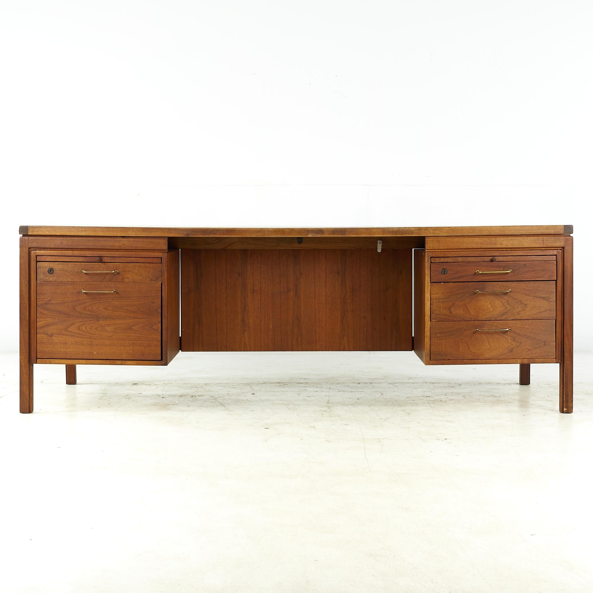 Jens Risom midcentury walnut and brass executive desk.

This desk measures: 81.25 wide x 36 deep x 28 high, with a chair clearance of 26.25 inches

All pieces of furniture can be had in what we call restored vintage condition. That means the