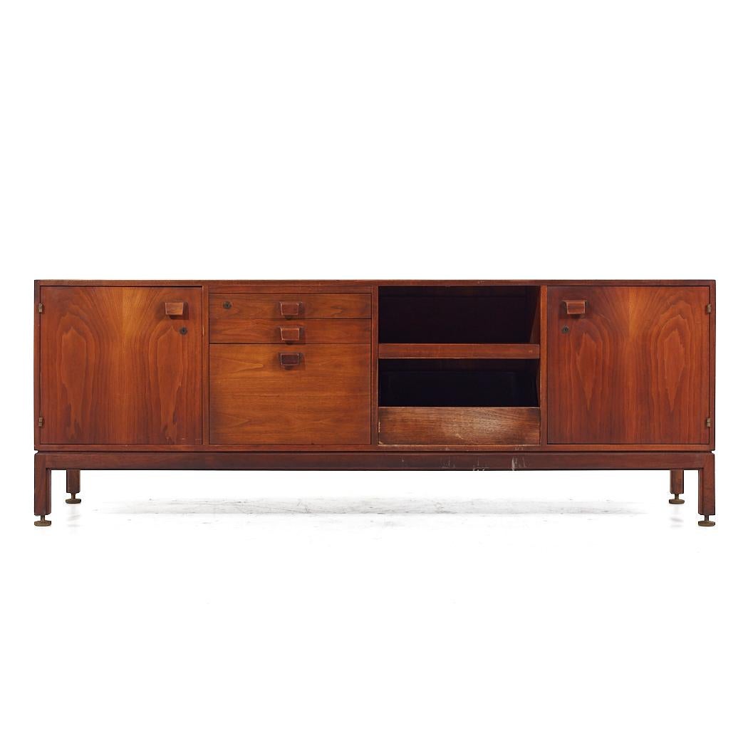 Jens Risom Mid Century Walnut Credenza

This credenza measures: 77.75 wide x 20 deep x 28.25 inches high

All pieces of furniture can be had in what we call restored vintage condition. That means the piece is restored upon purchase so it’s free of