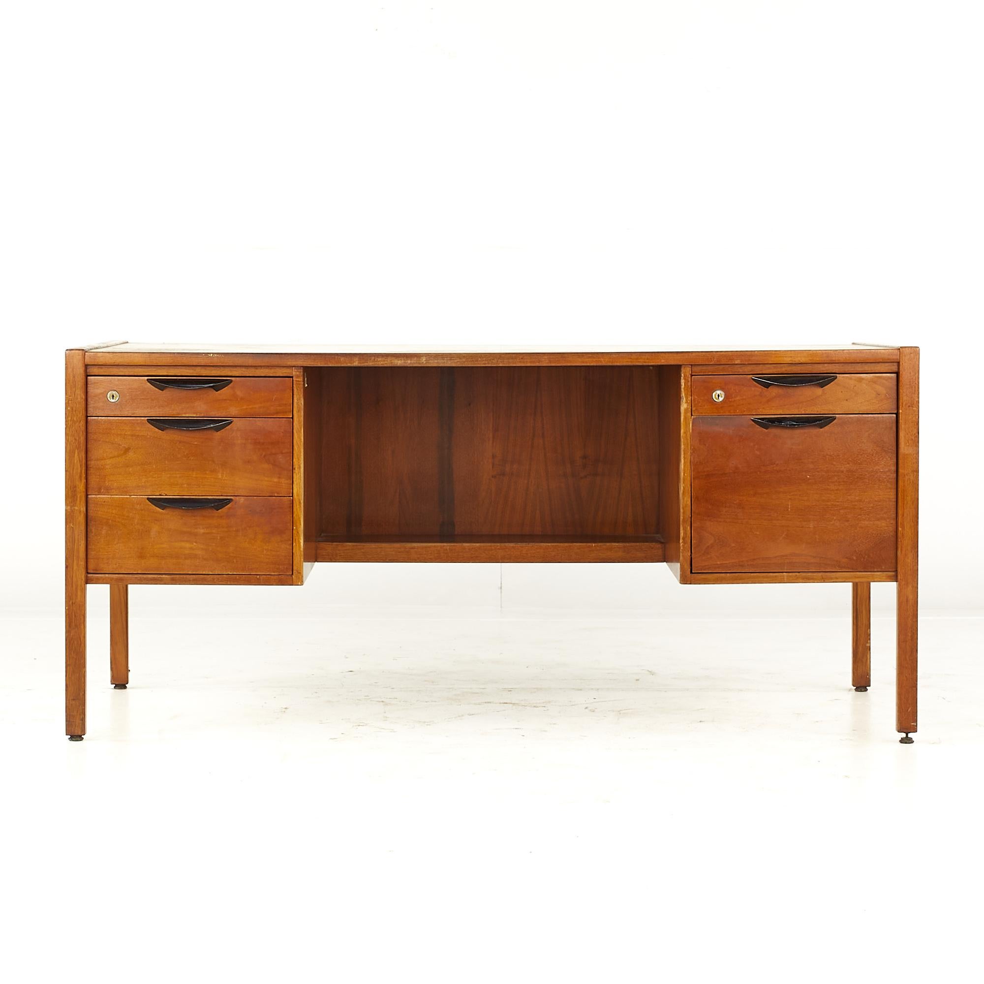 Jens Risom Mid Century walnut executive desk

This desk measures: 62 wide x 28 deep x 28.5 high, with a chair clearance of 27.25 inches

All pieces of furniture can be had in what we call restored vintage condition. That means the piece is