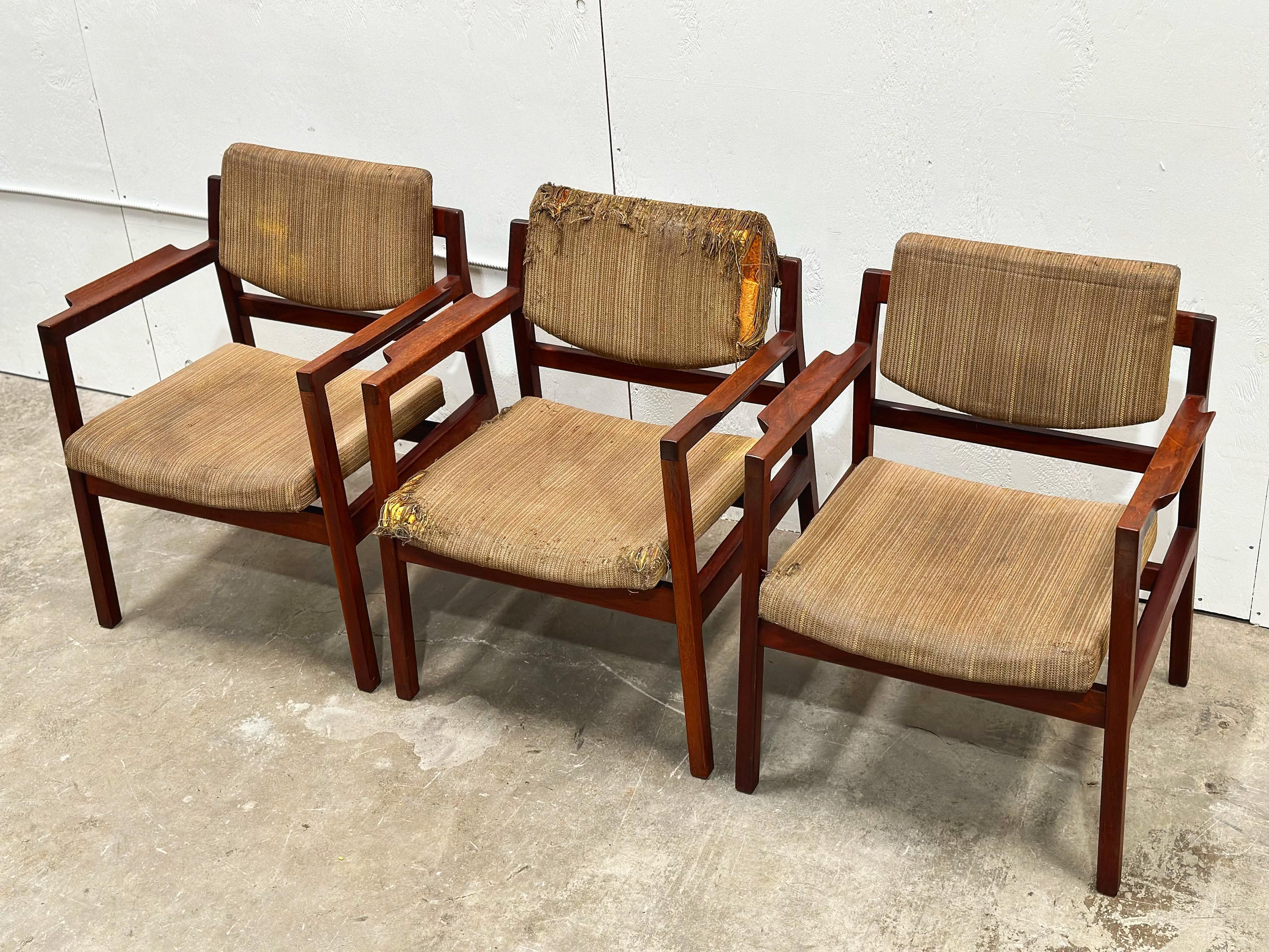 Set of eight (8) vintage mid century modern arm chairs by Jens Risom, circa late 1950s. Model C-170 in solid American black walnut with sculpted flared armrests. Stout and sturdy American craftsmanship with clean modern Danish modern design. 

The