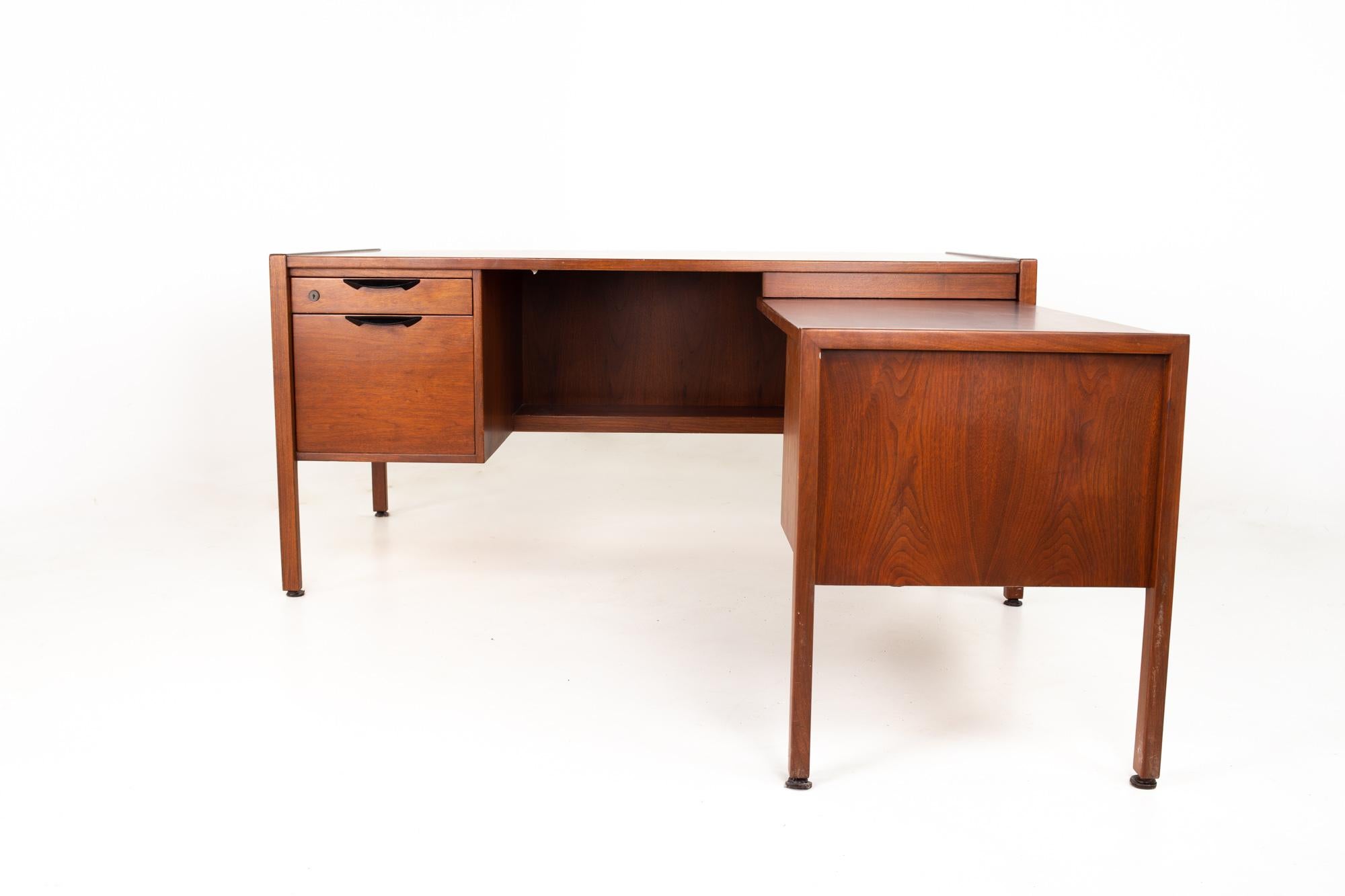 Jens Risom Mid Century walnut executive desk.
Desk measures: 62 wide x 34.75 deep x 28.75 inches high

All pieces of furniture can be had in what we call restored vintage condition. That means the piece is restored upon purchase so it’s free of