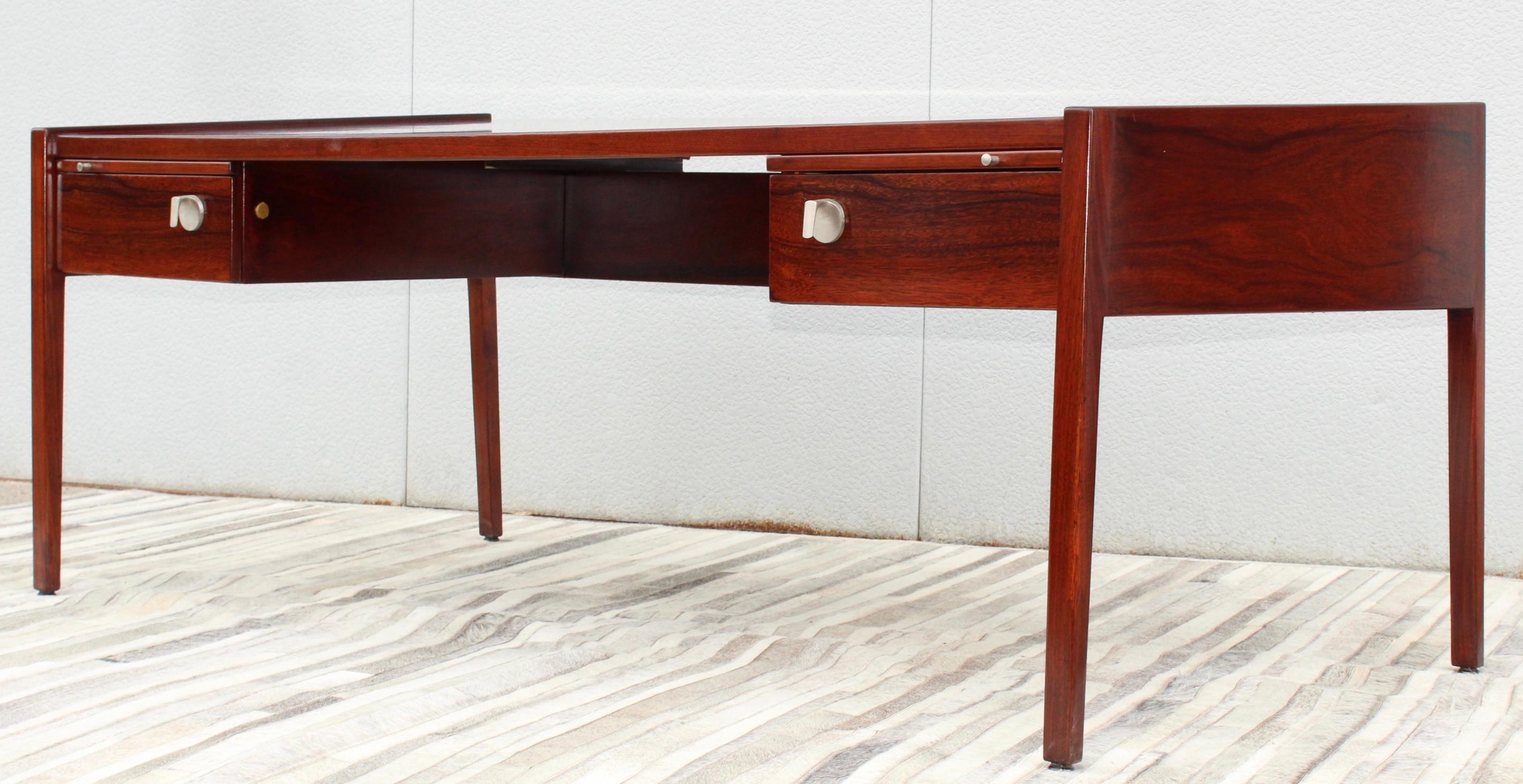 Stunning 1960's modernist rosewood executive desk designed by Jens Risom, in vintage condition lightly restored with two drawers and two pull out trays and chrome hardware. 

The back of the desk is 29.5'' the front of the desk is 27.5''.