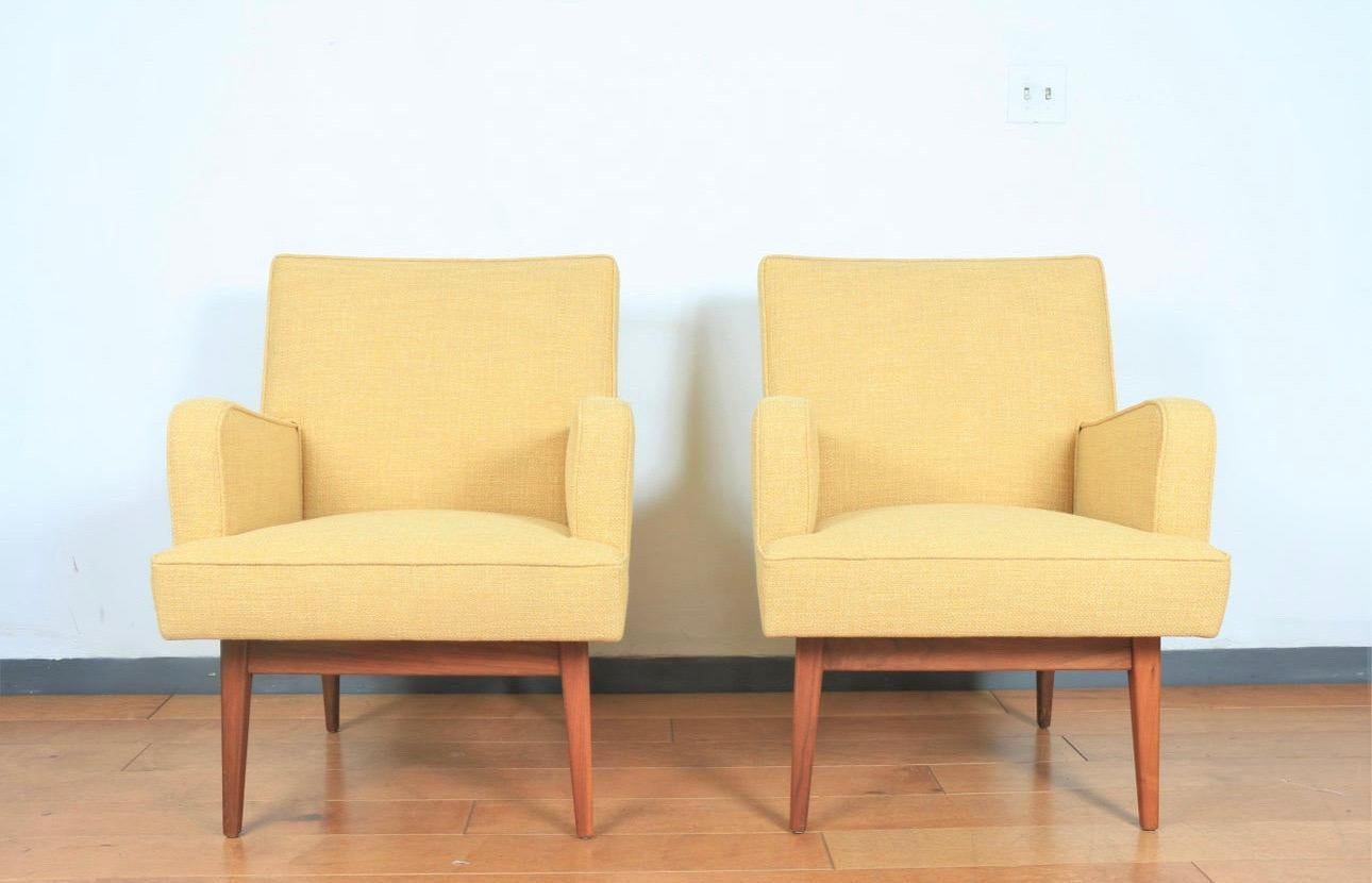Vintage Mid century pair of yellow reupholstered arm chairs in excellent condition.. Beautiful set of legs, all are strong and sturdy.. Will look great in any home or office..