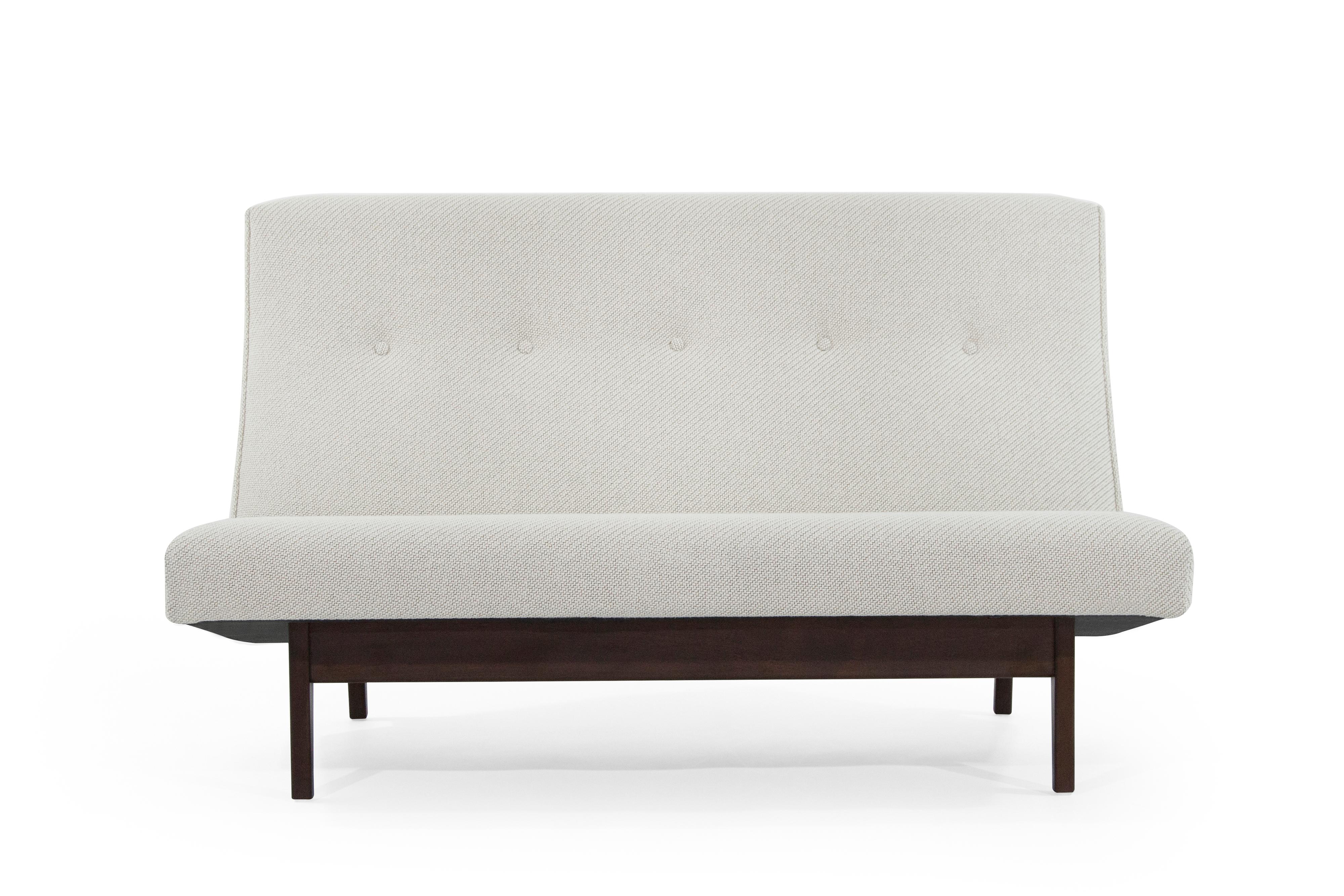 Stunning Jens Risom for Jens Risom designs settee, model U-251, circa 1950s. Sculptural walnut bases have been completely restored. Newly upholstered in an off-white Maharam/Kvadrat coda soft wool. 

Matching pair available, priced individually.