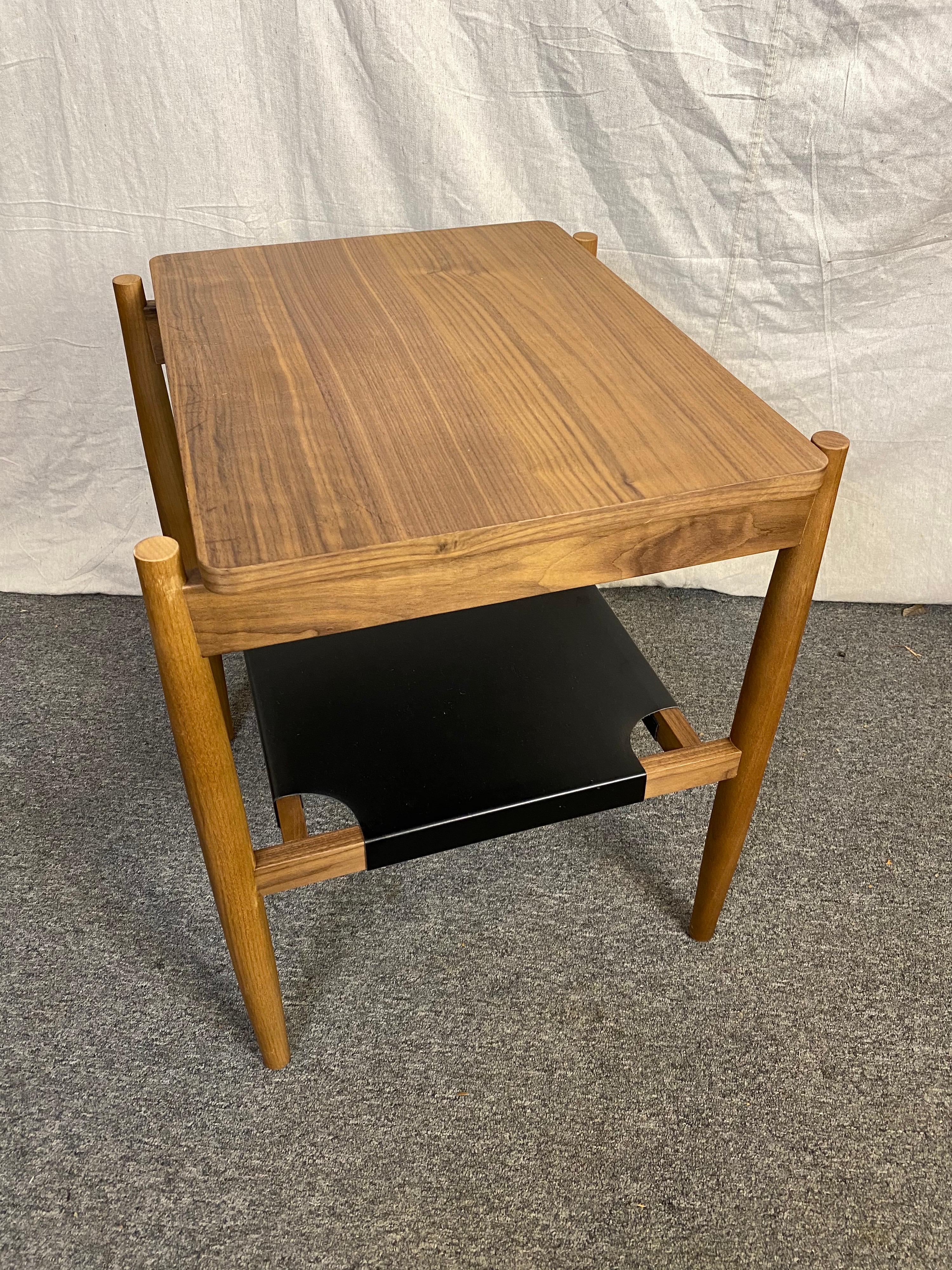 Jens Risom side table with a black leather stretched lower shelf. Table is just a few years old and out of Production. Overall in nice shape, top on very close examination shows fine scratches to top surface.