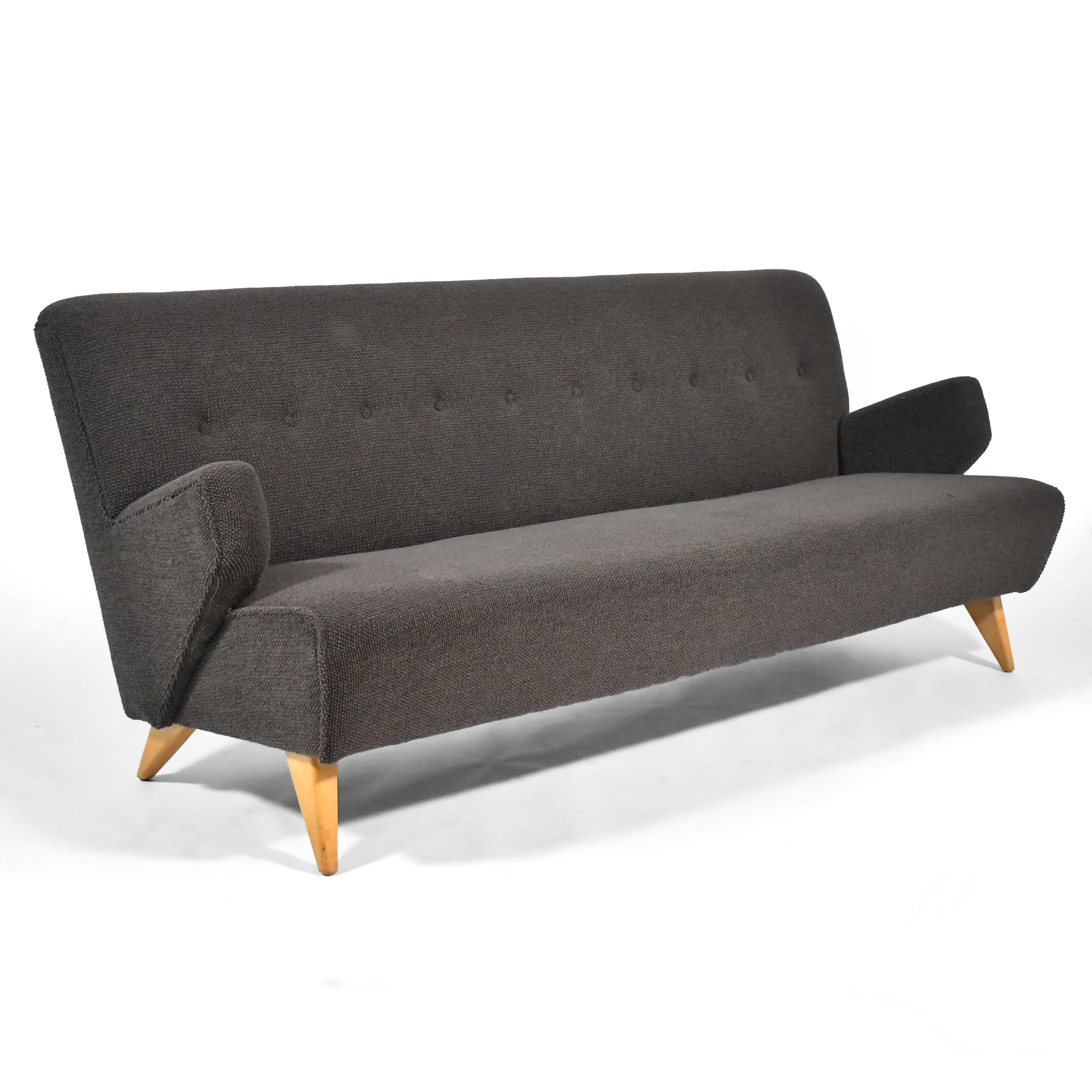 This early Risom model 37 sofa for Knoll is classic mid-century. Designed in 1946, the dynamic, but restrained form speaks to Risom's Scandinavian heritage. The upholstered body is supported by splayed tapered birch legs. The seat and back have