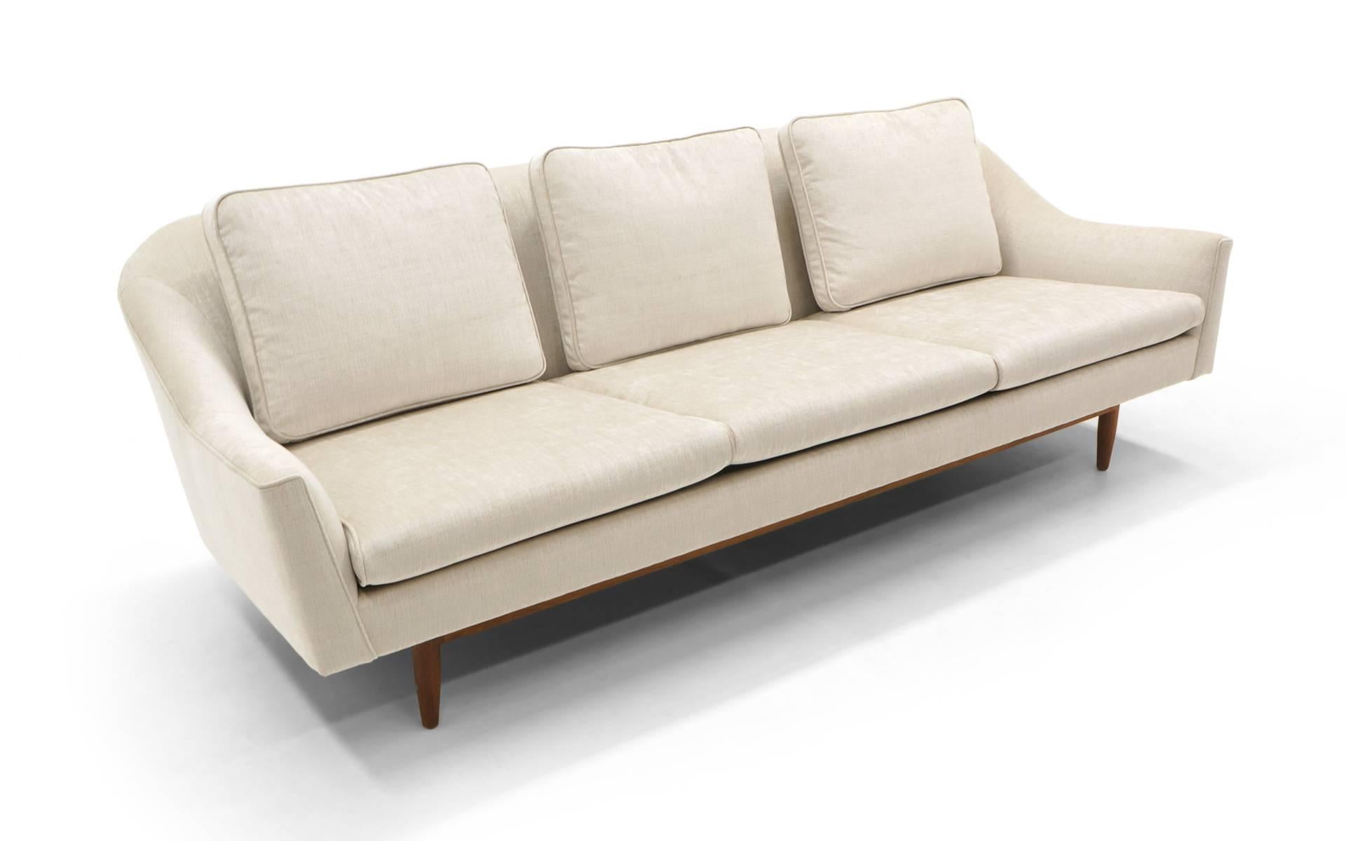 Stunning sofa designed by Jens Risom for Jens Risom Designs. Maybe the most comfortable modern sofa we have ever had. Expertly restored and reupholstered in an creamy / ivory Knoll fabric. Beautiful soft texture. Solid walnut base. Great sofa.