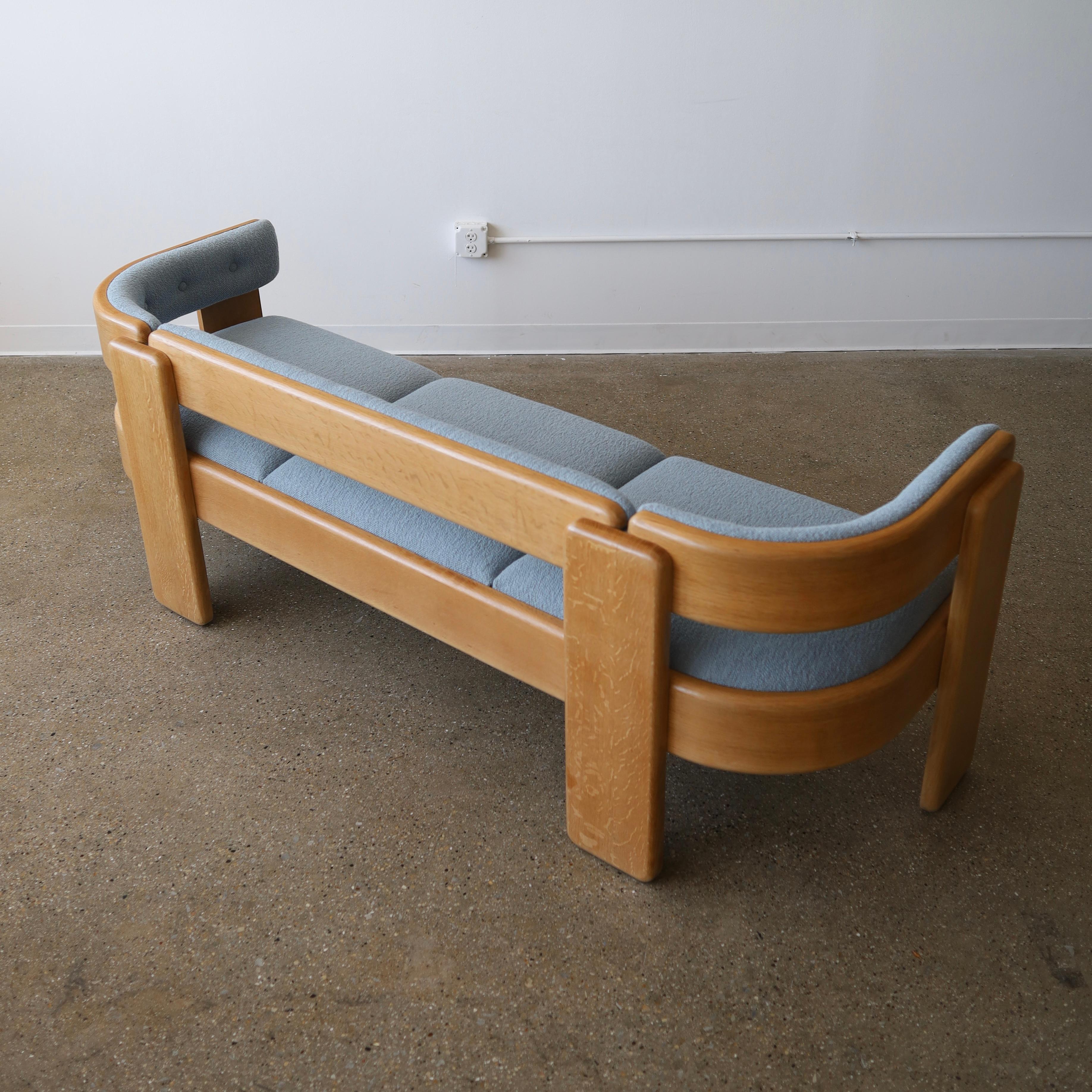 This sofa has been fully refinished, features new foam, and has been reupholstered in Maharam “Hearth” fabric - it feature a solid, white oak frame that has been steam-bent. There are some minor flaws including stabilized cracking and general scuffs