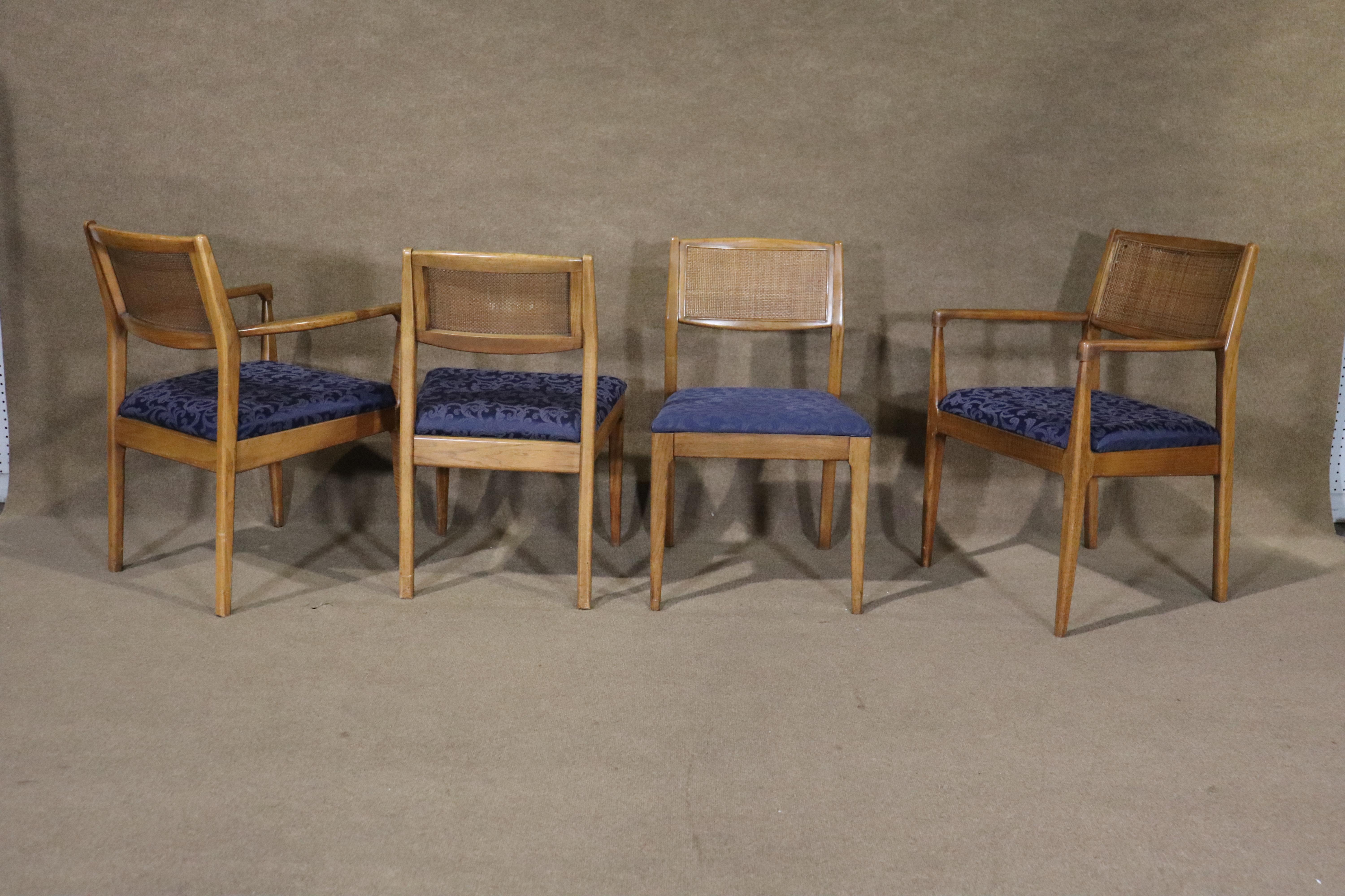 Set of mid-century caned back dining chairs in the style of Jens Risom. Two arm chairs and four side chairs. Slender arms and tapered legs ad a modern feel to your dining room.
Arm chairs: 33