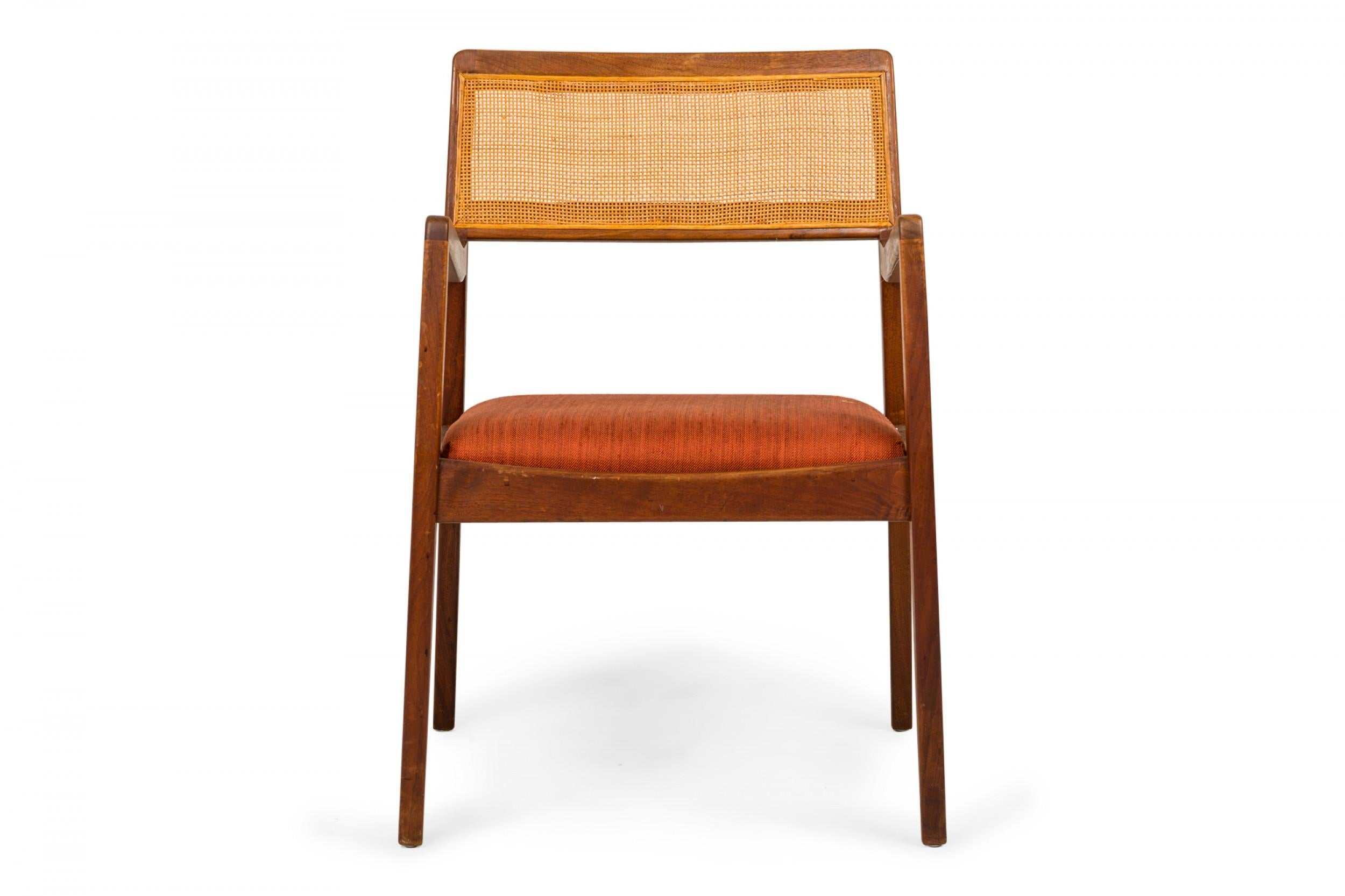 Set of 3 Danish mid-century dining/conference armchairs with teak wood frames, caned seat backs, and faintly striped orange fabric upholstered seats. (JENS RISOM)(PRICED AS SET)
 