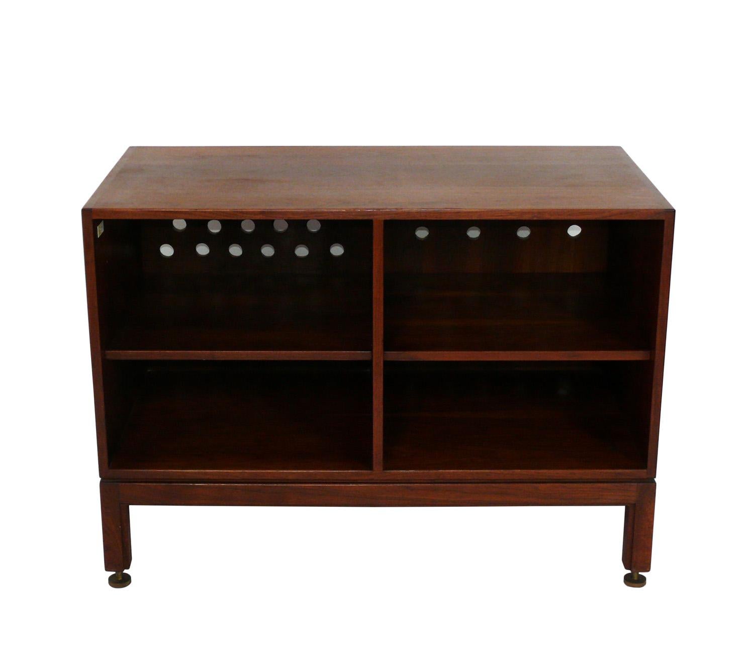 Clean Lined Walnut Credenza, designed by Jens Risom, American, circa 1960s. Signed with Risom label. Jens Risom was definitely influenced by Danish Modern design, and this piece is no exception, with a clean lined design in walnut with substantial