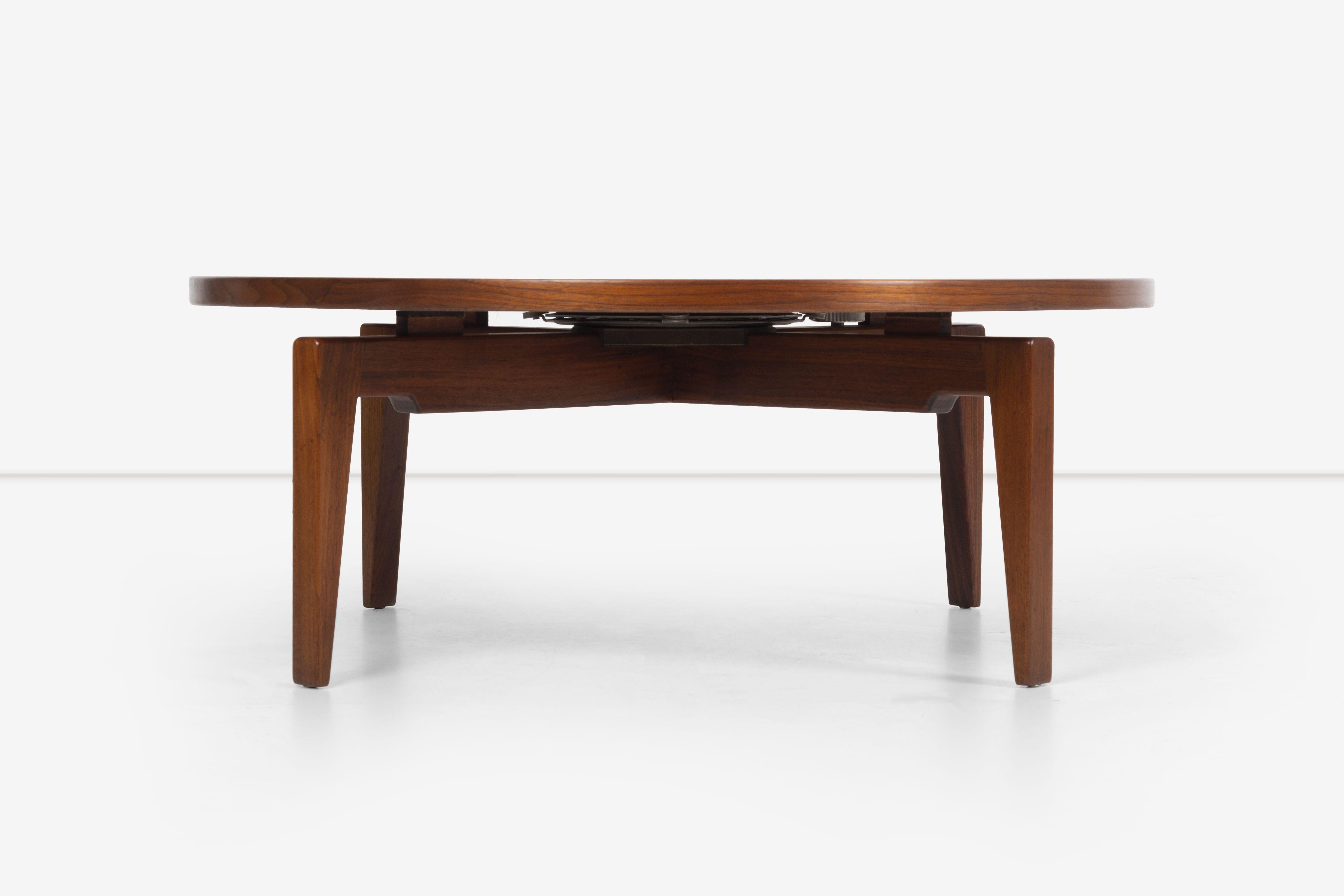 Jens Risom Walnut Coffee Table; model 4010 designed 1961 revolving top with locking mechanism, solid walnut tapered legs.