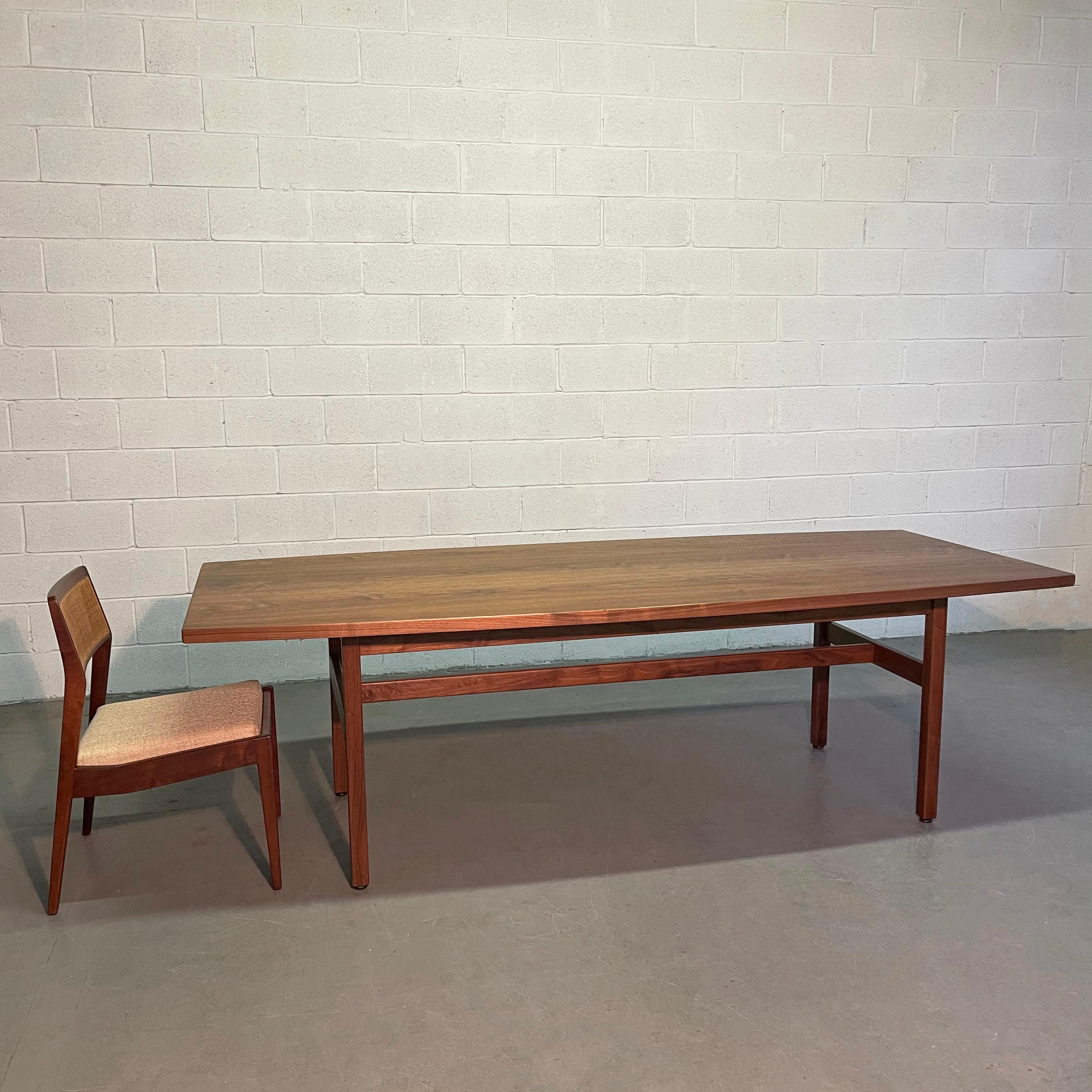 Large, 8 ft, Mid-Century Modern, walnut, conference or dining table by Jens Risom features a curved, surf board top that tapers to 36 inches at each end with trestle base.
