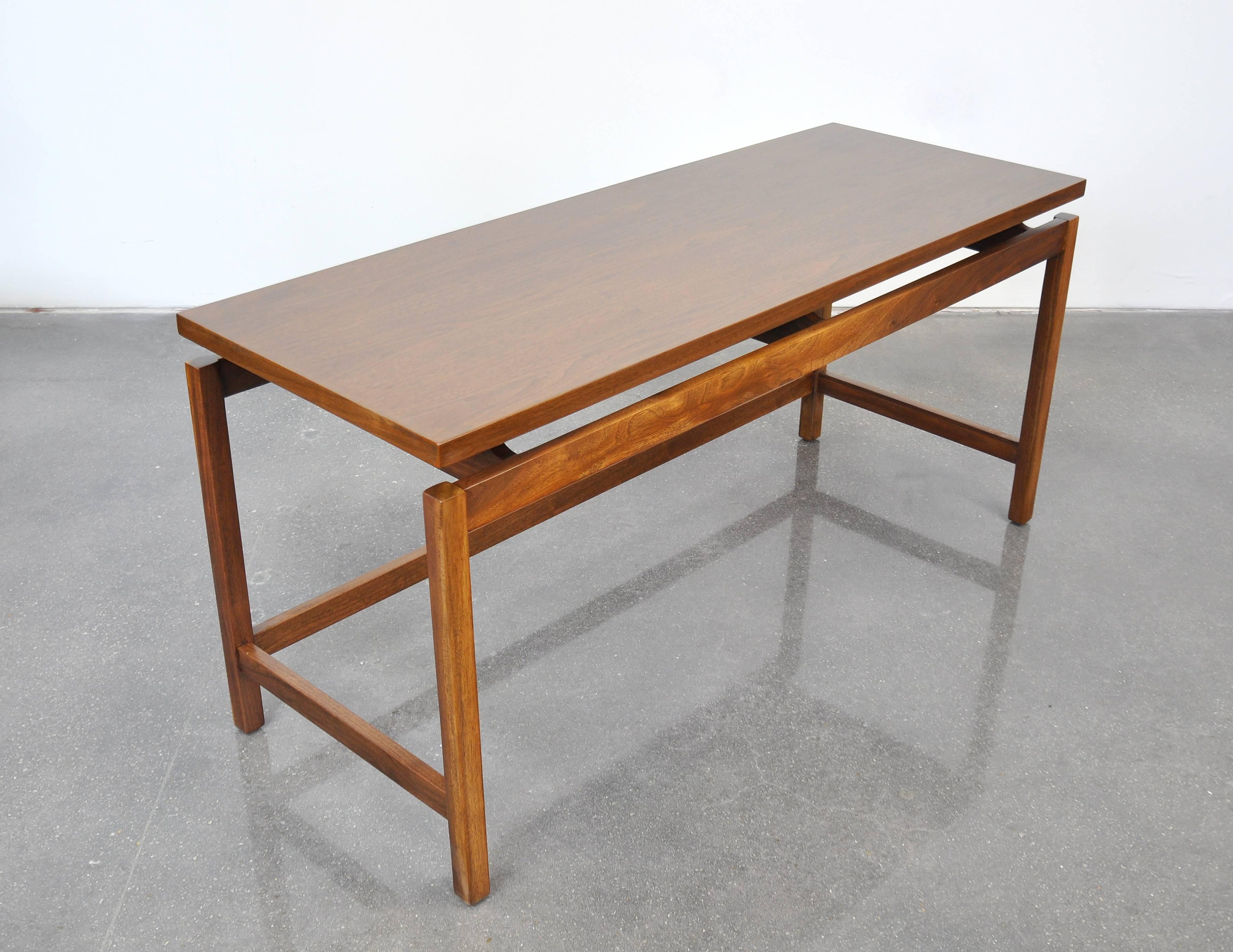 A vintage midcentury Danish modern walnut console, designed by Jens Risom, dating from the 1960s. The low table features a Minimalist design with floating top typical of Risom, allowing it to be placed in virtually any decor or setting, for either