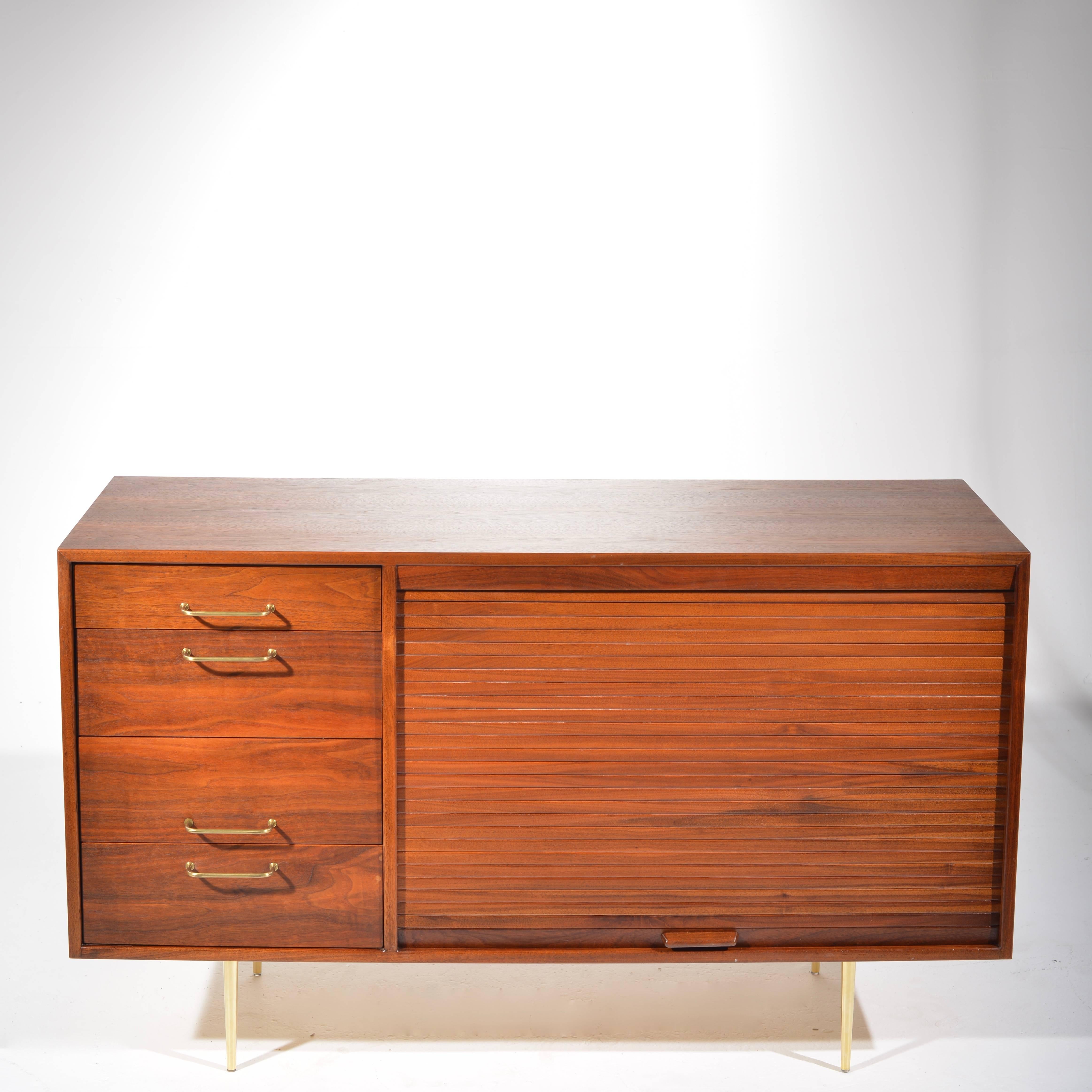 A beautiful walnut credenza buffet designed by Jens Risom, circa 1960. It features the highest quality in materials and cabinetry, solid maple interiors and drawers, and an large adjustable shelf. Everything operates smoothly. 

Local pick up is