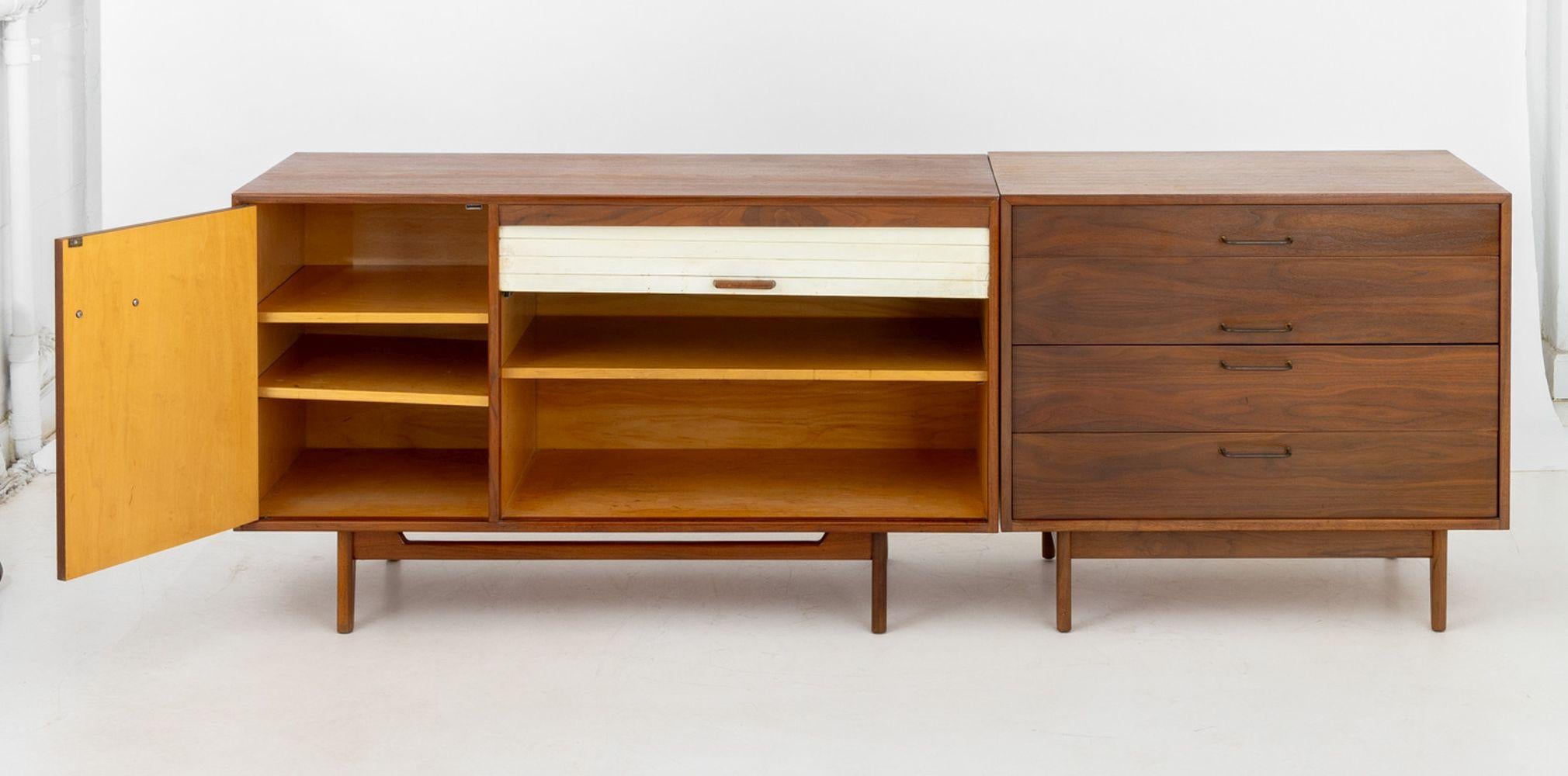 Jens Risom Walnut Two-Piece Credenza, the left side having single cabinet with three shelves and white vinyl tambour door opening to two shelves, the right side with four drawers having brass pulls, each piece on four tapered legs. 31.75