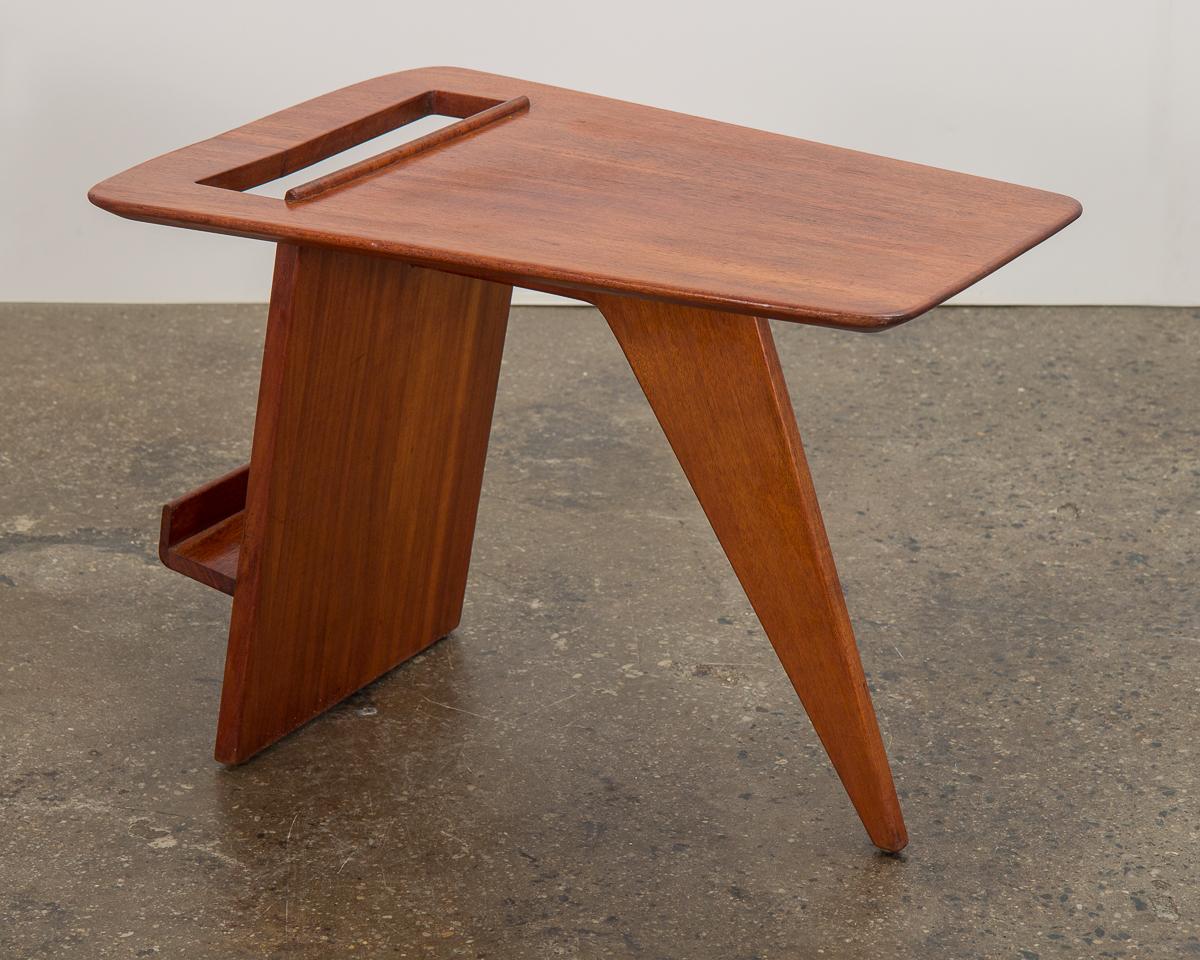 Original model T.539 walnut side table, designed by Jens Risom in 1949. Fantastic angular profile is sleek and modern. Wedge-shaped top exhibits beautiful walnut wood grain. Functionality added with a magazine rack. Exemplary construction, with a