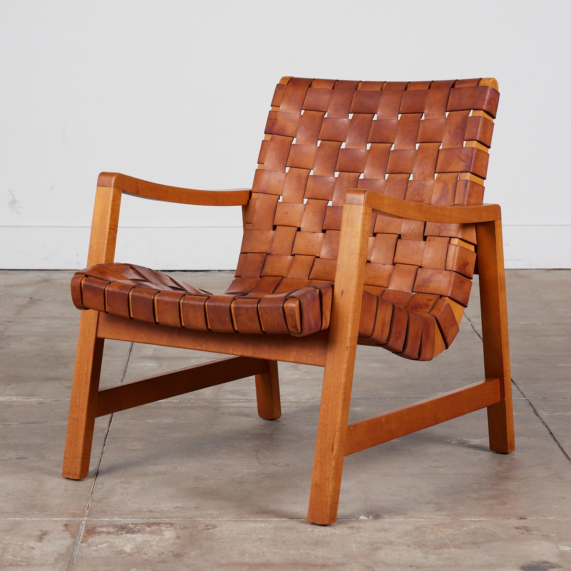 Lounge chair by Jens Risom for Knoll, circa 1940s. This 1943 design was Risom's first design for Knoll, where he had been brought on as design director. This piece features a birch frame, original brown leather webbing and steel nail head details