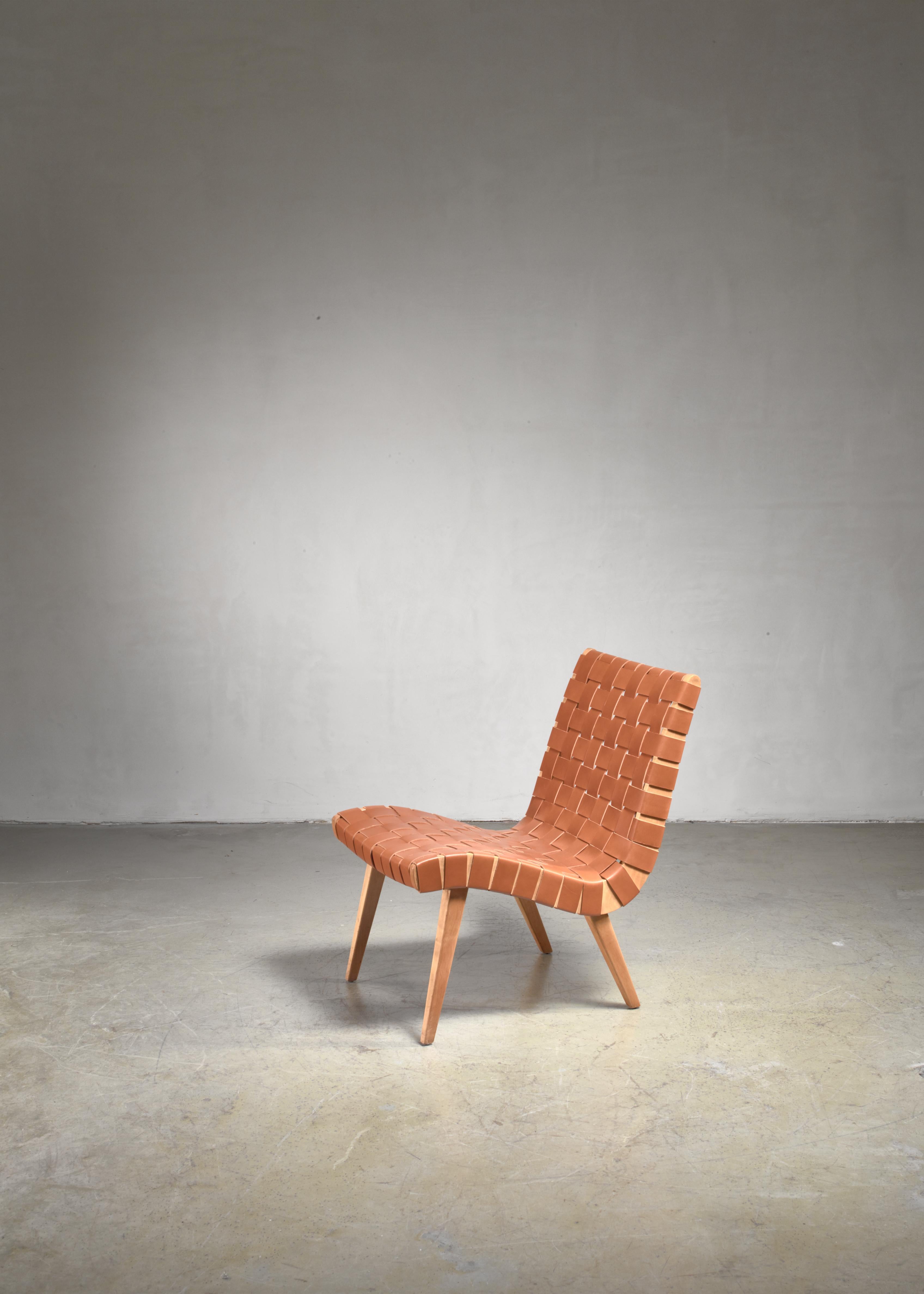 An early Jens Risom model 654W chair for Knoll, with a curved seating upholstered with a brown leather webbing. The chair has been professionally upholstered with new leather in our in-house atelier.