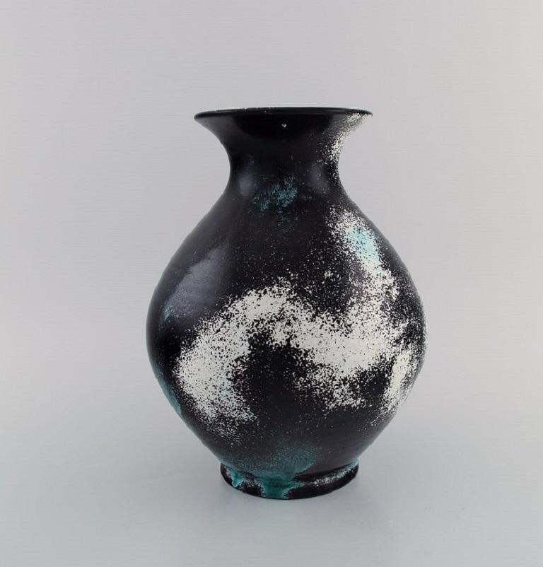 Jens Thirslund for Kähler, HAK. 
Vase in glazed stoneware. Beautiful glaze in shades of black, white and turquoise. 1920s / 30s.
Measures: 26 x 20 cm.
In excellent condition.
Signed.