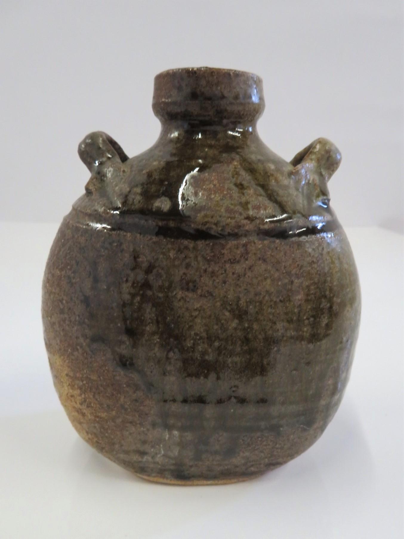 REDUCED FROM $350.....From the studio of Elinor Jensen, a two handled raku greenish saltglaze vessel signed in the clay on the bottom Jensen. A beautiful pot.
Measurements: 6 inches high x 5 inches wide x 3 1/2 inches deep.
 A member of the Ceramic