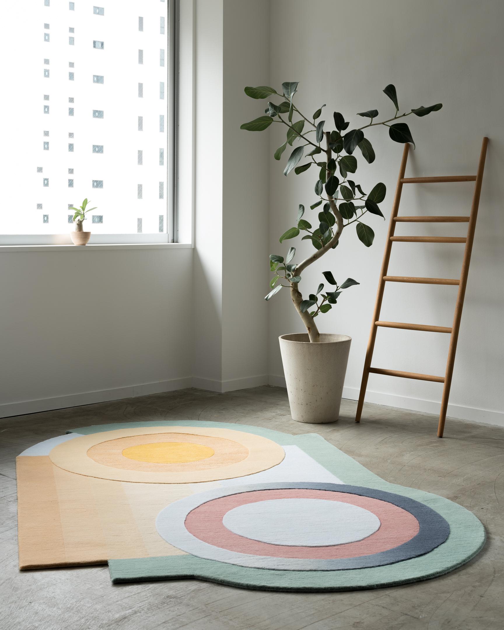 This unique hand-knotted Himalayan wool and silk area rug was designed to captivate and calm the senses. Expertly hand knotted ombres woven at 100 knots per inch, seem to capture a reflection on a pool of water in this playful asymmetrical design.