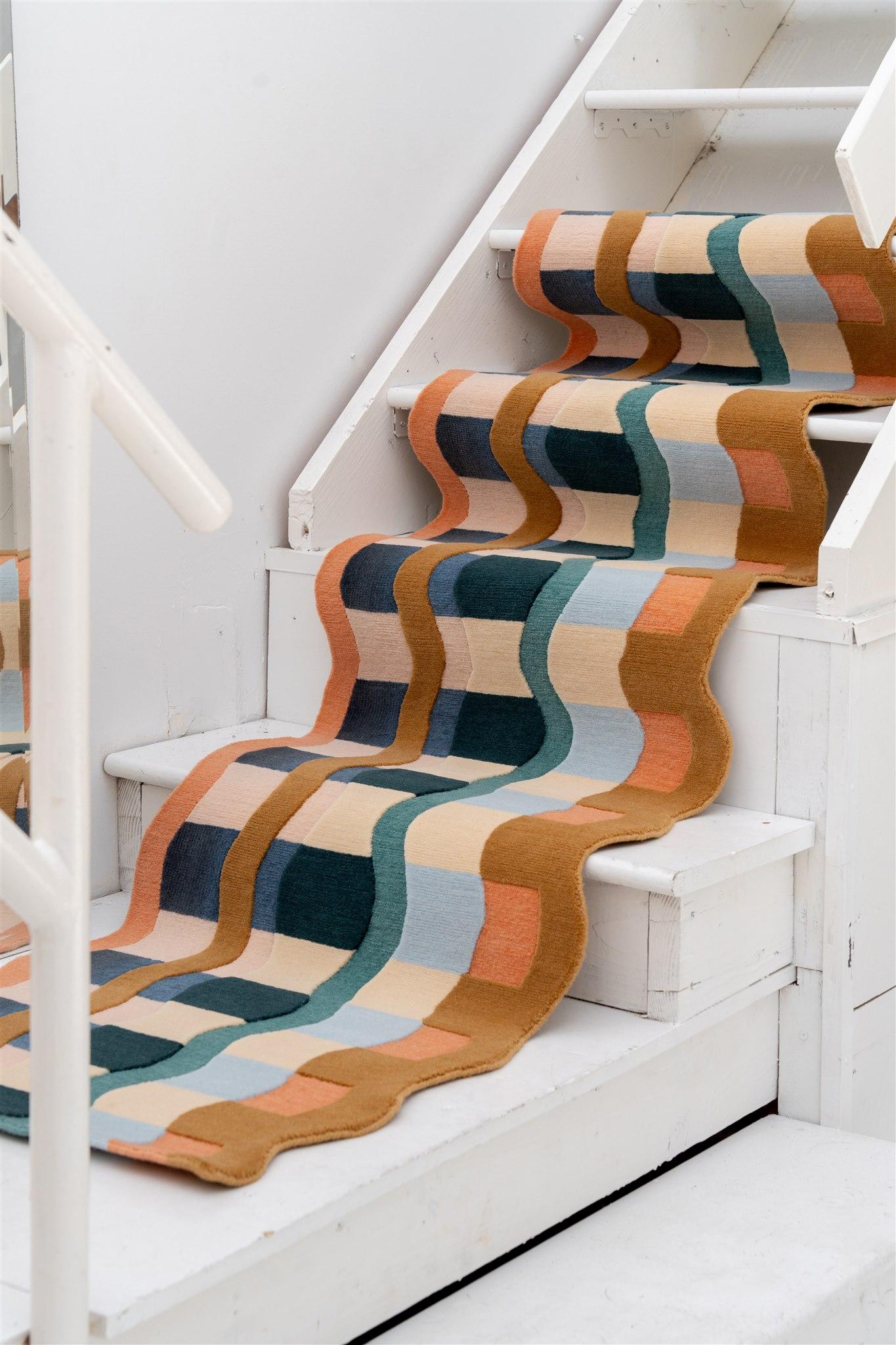 This unique hand-knotted Himalayan wool runner was inspired by the dynamic rhythms of the city of Osaka. High rise apartment buildings with their endless rows of balconies are captured in an energetic play of pattern and geometry. Let your eyes