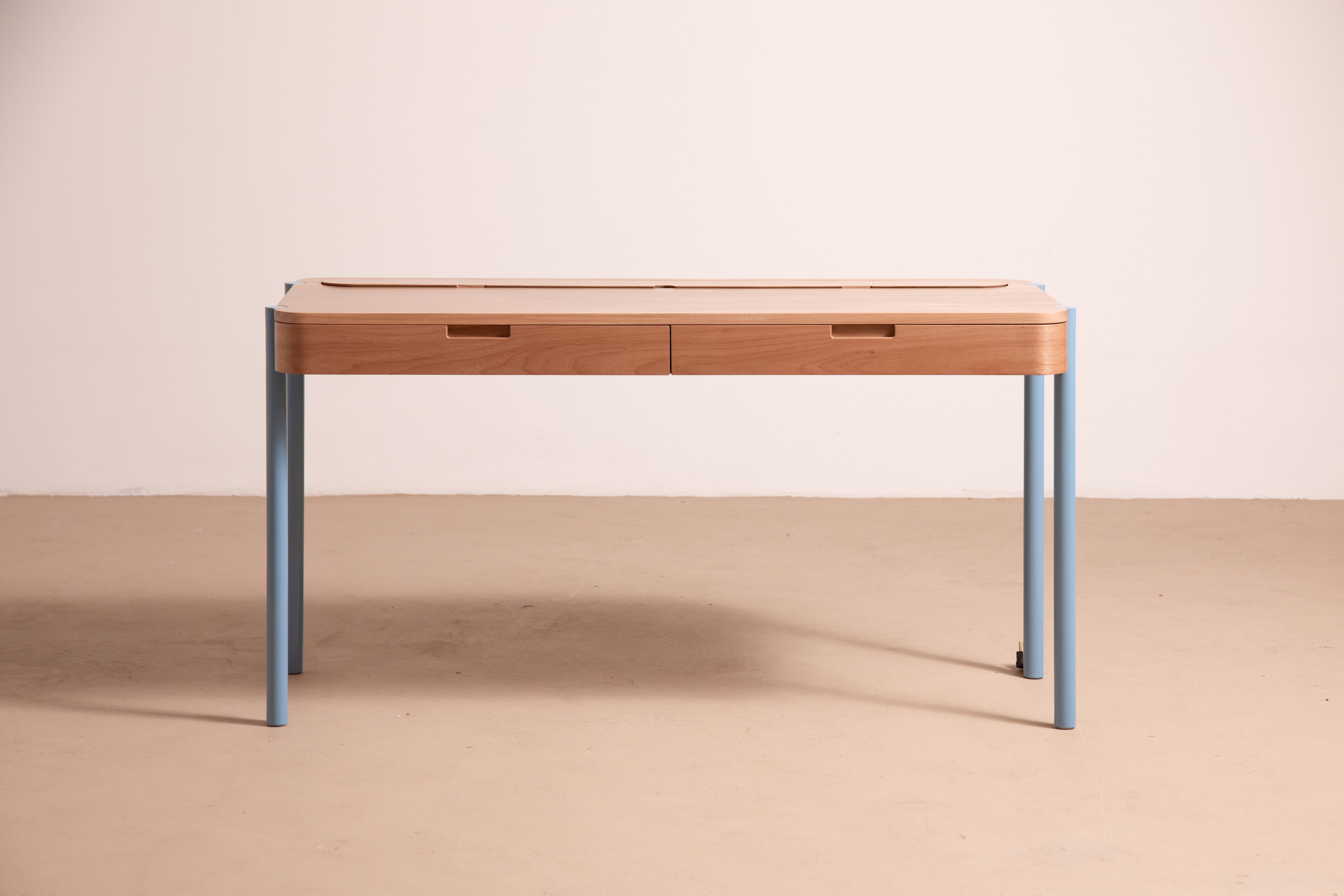Jequitiba, Blue Gambito Writing Desk by Andreas Anwander
Dimensions:  W 146 x D 60 x H 75 cm
Materials: Solid Jequitibá wood, Carbon, Steel, Brass.
Weight: 25 kg.

A writing desk with precise fittings, inbuilt sockets, a beautiful combination of