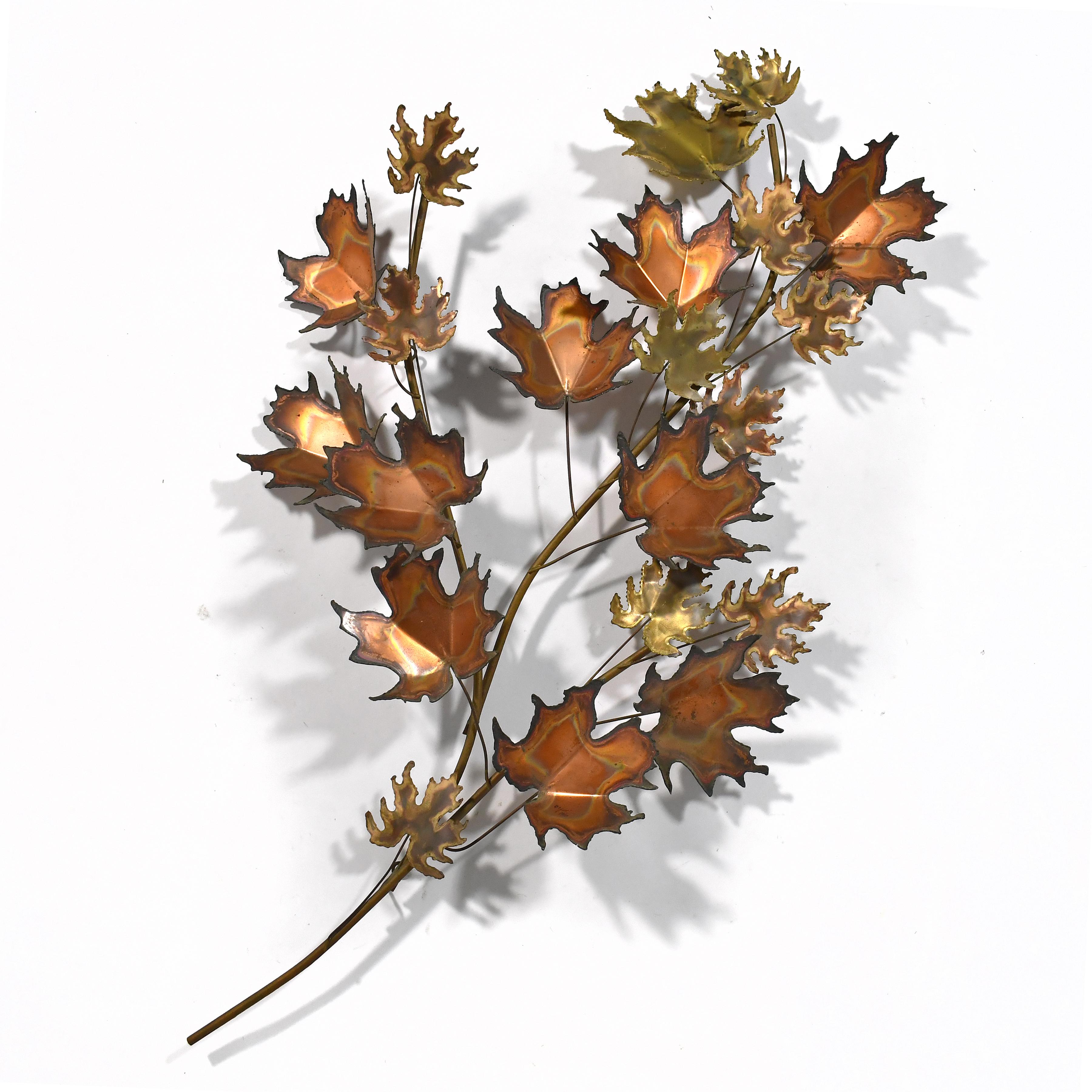 With a delightful autumnal touch, this dynamic composition of textured leaves in mixed metals by C. Jere' activates any surface it is mounted on and creates delightful shadows. Signed and dated 1971.

52