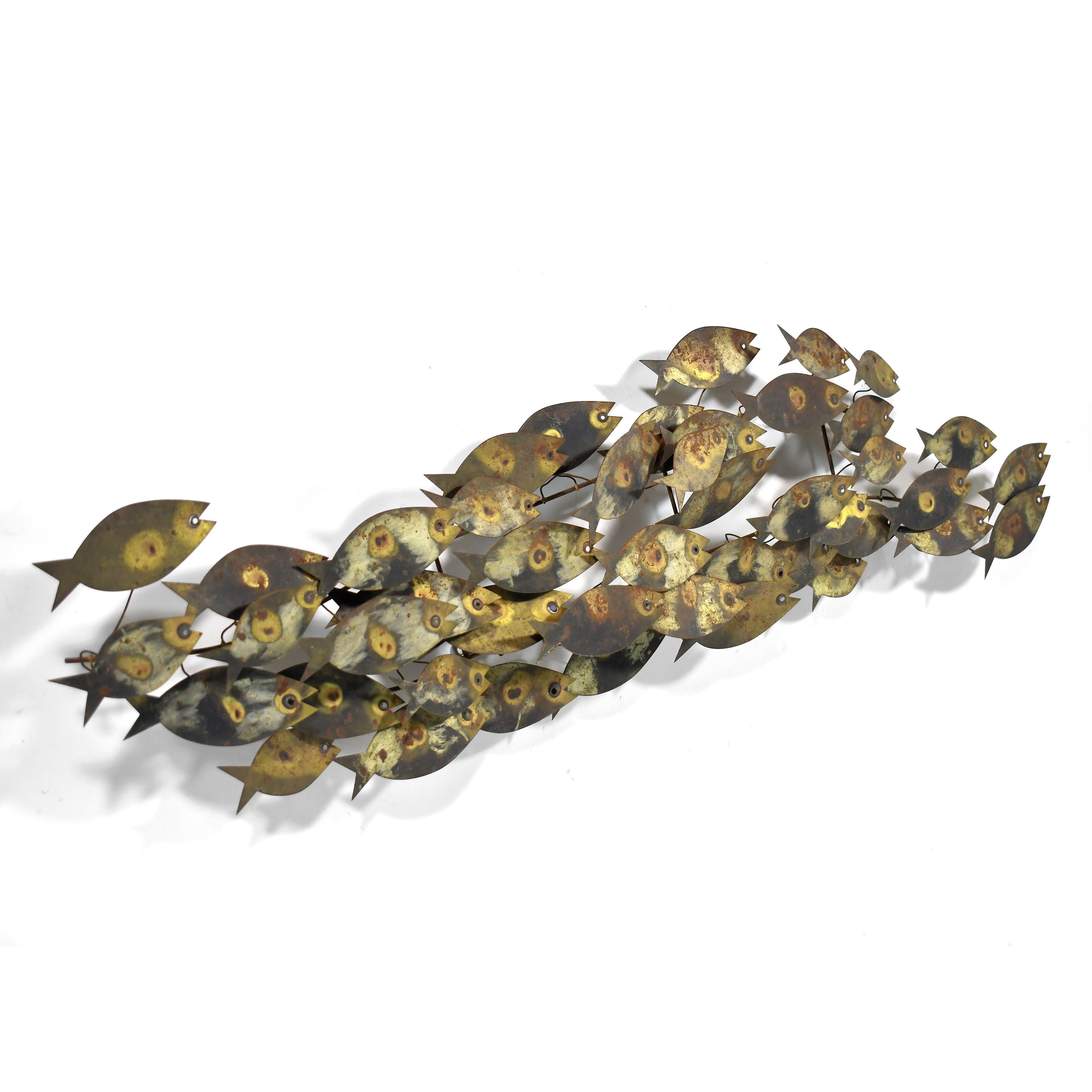 This early design by Curtis Jere for Artisan House features a dense school of fish swimming together.

Cleverly balancing the representational and abstract, the sculpture activates any wall it is hung on.

14