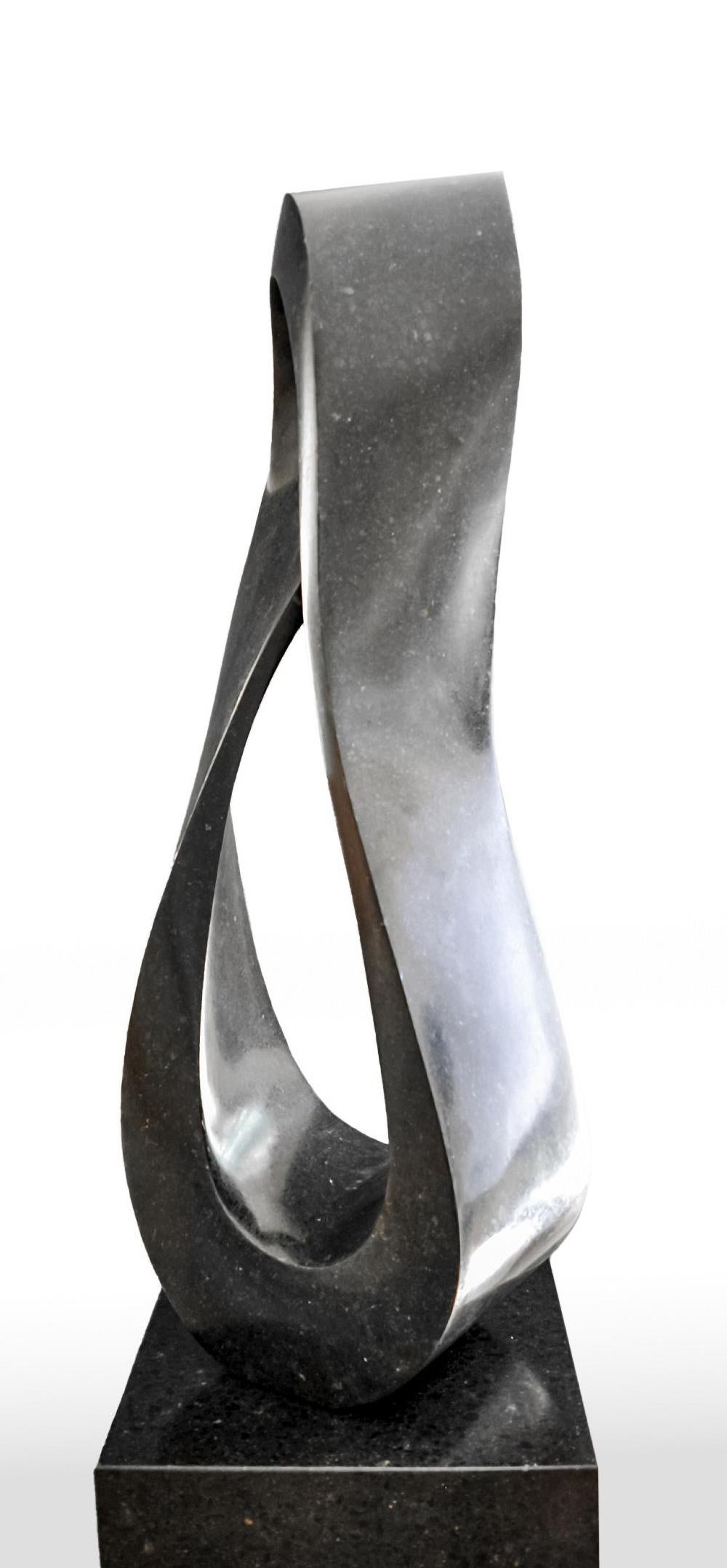 Smooth-surfaced, black granite flecked almost imperceptibly with copper and white has been engineered into an elegant Mobius strip by sculptor Jeremy Guy. This sculpture is numbered in an edition of 50 and can be purchased on a commission basis,