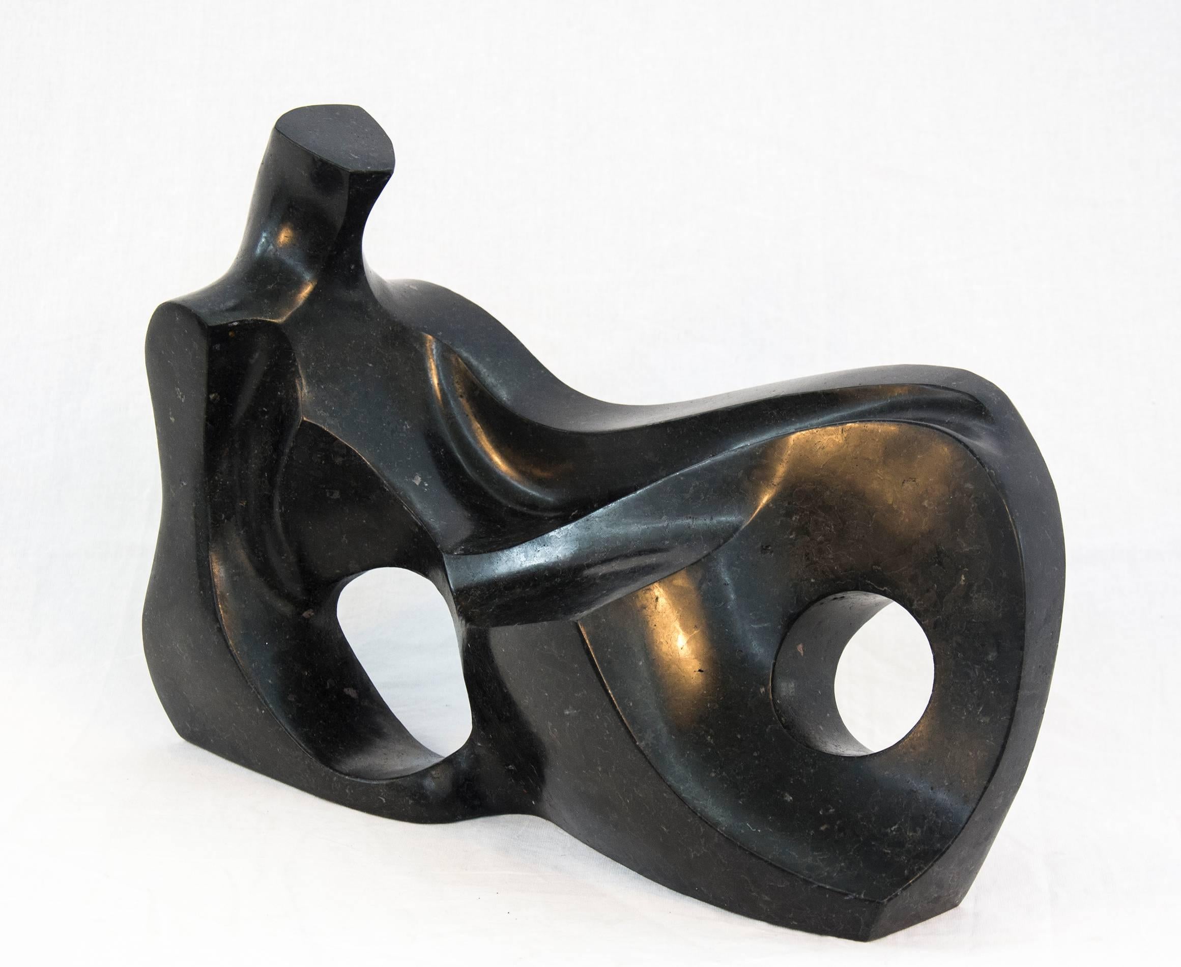 Smooth surfaced, black granite has been engineered intio an elegant and classic depiction of a reclining figure by Jeremy Guy. This work is number 10 in an edition of 50. The formalist play of positive and negative space reveals an inspiration from